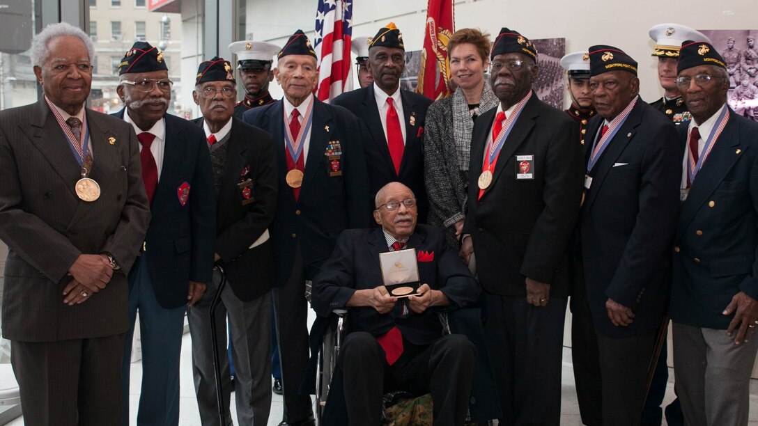 Hiram Knowles, along with fellow Montford Point Marines and supporters, pose for a photo at the conclusion of the ceremony for Knowles receiving the Congressional Gold Medal on Feb.7, 2015. Knowles was one of over 400 Montford Point Marines to be awarded since 2012. 