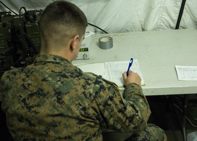 Cpl. Travis Lord, a field radio operator with Combat Logistics Regiment 25, 2nd Marine Logistics Group, writes in a log book of communications during a tent exercise aboard Camp Lejeune, N.C., Jan. 28, 2015. Marines with CLR-25 conducted the tent exercise to further their abilities in communications during the week-long exercise. The Marines conducted a short work up to the exercise by familiarizing themselves with the gear a week prior to the event. Marines from CLR-25 worked with Marines from Supply Battalion and Maintenance Battalion transmitting information back and forth.  (U.S. Marine Corps photo by Pfc. Dalton A. Precht/released)