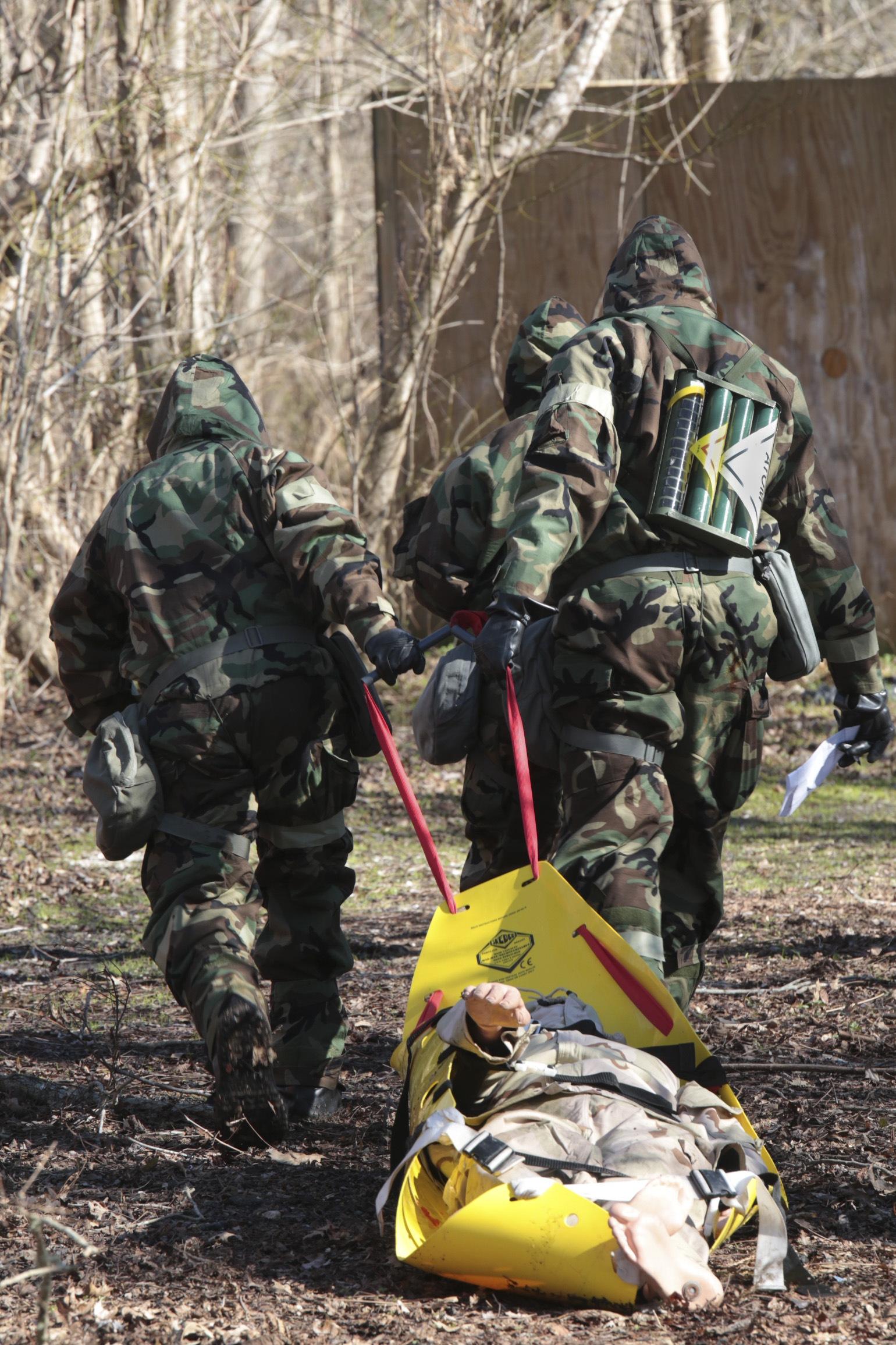 Marines from Marine Forces Reserve transport a casualty from a contaminated area to a safe zone during a chemical, biological, radiological and nuclear defense training simulation aboard Naval Air Station Joint Reserve Base New Orleans, Feb. 5, 2015. Marines with the survey team are responsible for securing the perimeter and extracting any casualties. The CBRN defense training equips Marines from diverse units, with the proper knowledge and readiness needed to handle a real combat zone situation.   (U.S. Marine Corps photo by Lance Cpl. Ian Ferro)