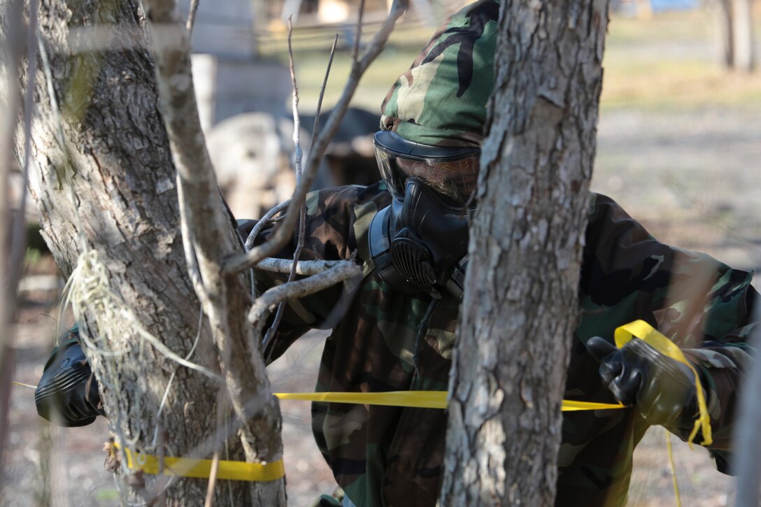 A Marine from Marine Forces Reserve secures the perimeter of a contaminated area during a chemical, biological, radiological and nuclear defense training simulation aboard Naval Air Station Joint Reserve Base New Orleans, Feb. 5, 2015. Marines with the survey team are responsible for securing the perimeter and extracting any casualties. The CBRN defense training equips Marines from diverse units, with the proper knowledge and readiness needed to handle a real combat zone situation.  (U.S. Marine Corps photo by Lance Cpl. Ian Ferro)
