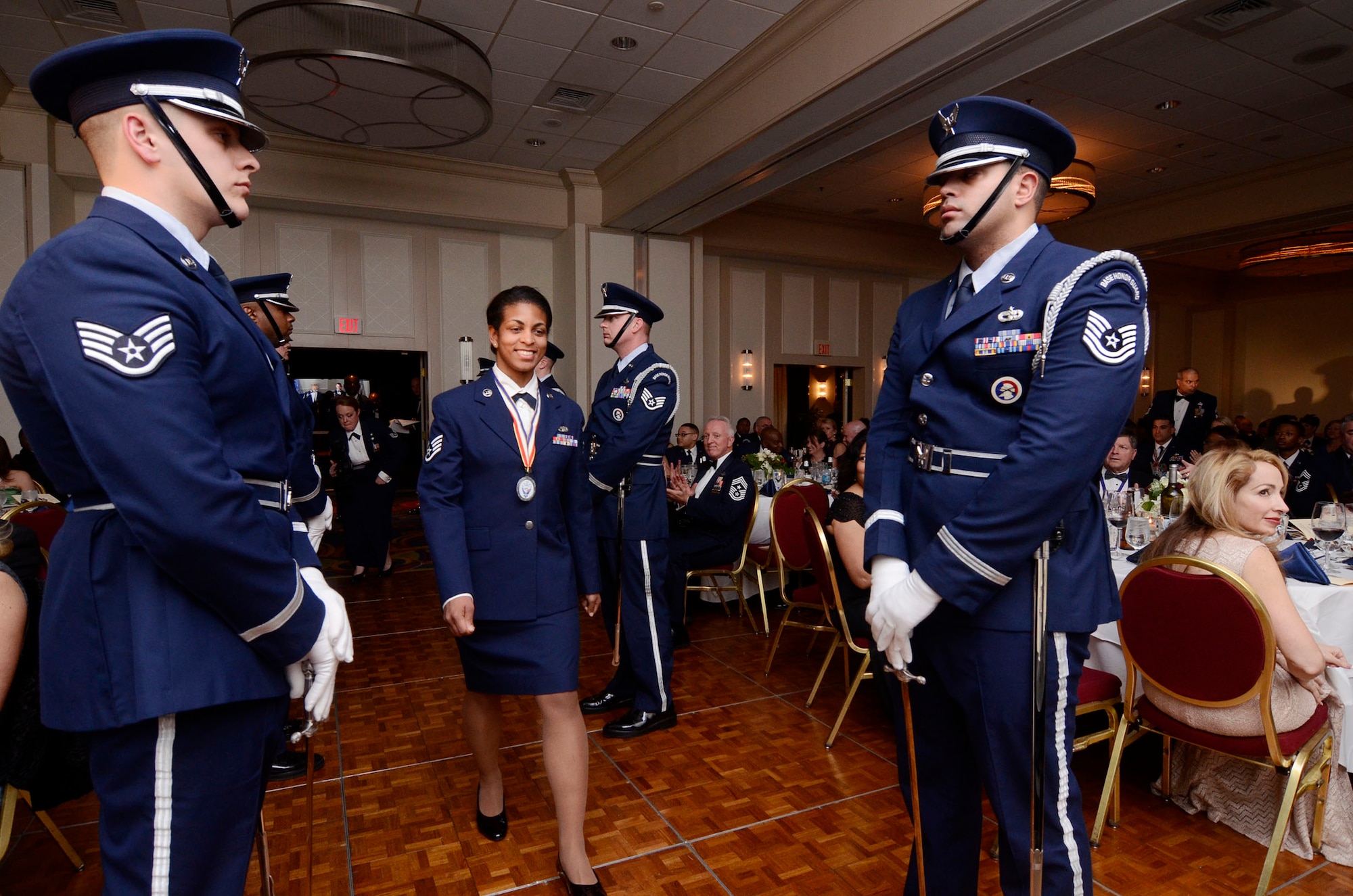 Staff Sgt. Tiffany McGregor from the 80th Aerial Port Squadron enters the room as one of three Airman of the Year nominees during the First Annual Dobbins Recognition Ceremony held in Marietta, Ga. Feb. 7, 2015. McGregor was selected as the winner. The ceremony recognized individuals who demonstrated the capability to excel, and present themselves as the best of 2014. (U.S. Air Force photo/Don Peek)