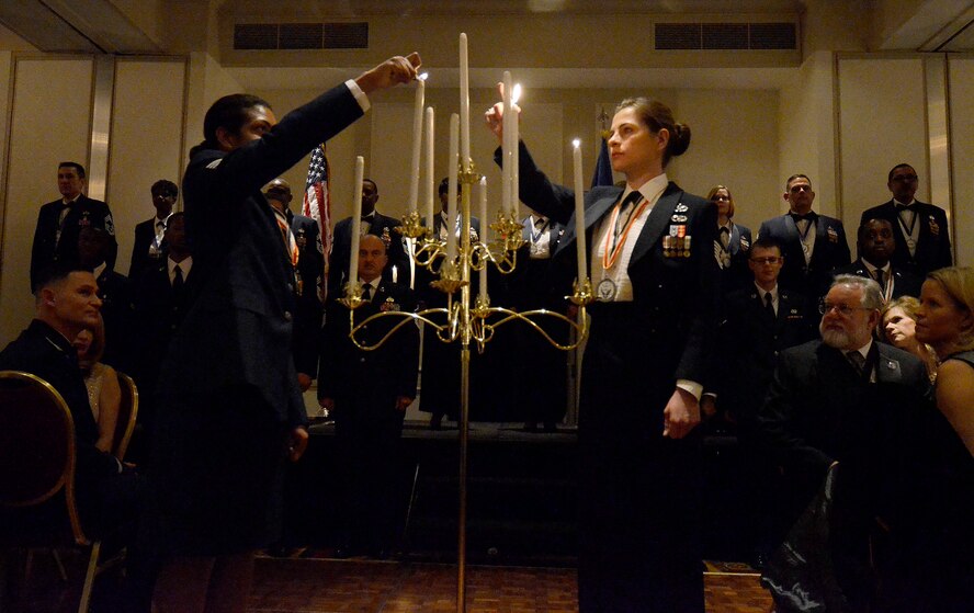 Staff Sgt. Tiffany McGregor and Tech. Sgt., both from the 80th Aerial Port Squadron, light candles 5th and 6th candles, performing the Noncommissioned Officer portion of the Candle Lighting Ceremony honoring newly selected Chief Master Sergeants during the First Annual Dobbins Recognition Ceremony held in Marietta, Ga. Feb. 7, 2015. The ceremony recognized individuals who demonstrated the capability to excel, and present themselves as the best of 2014. (U.S. Air Force photo/Don Peek)