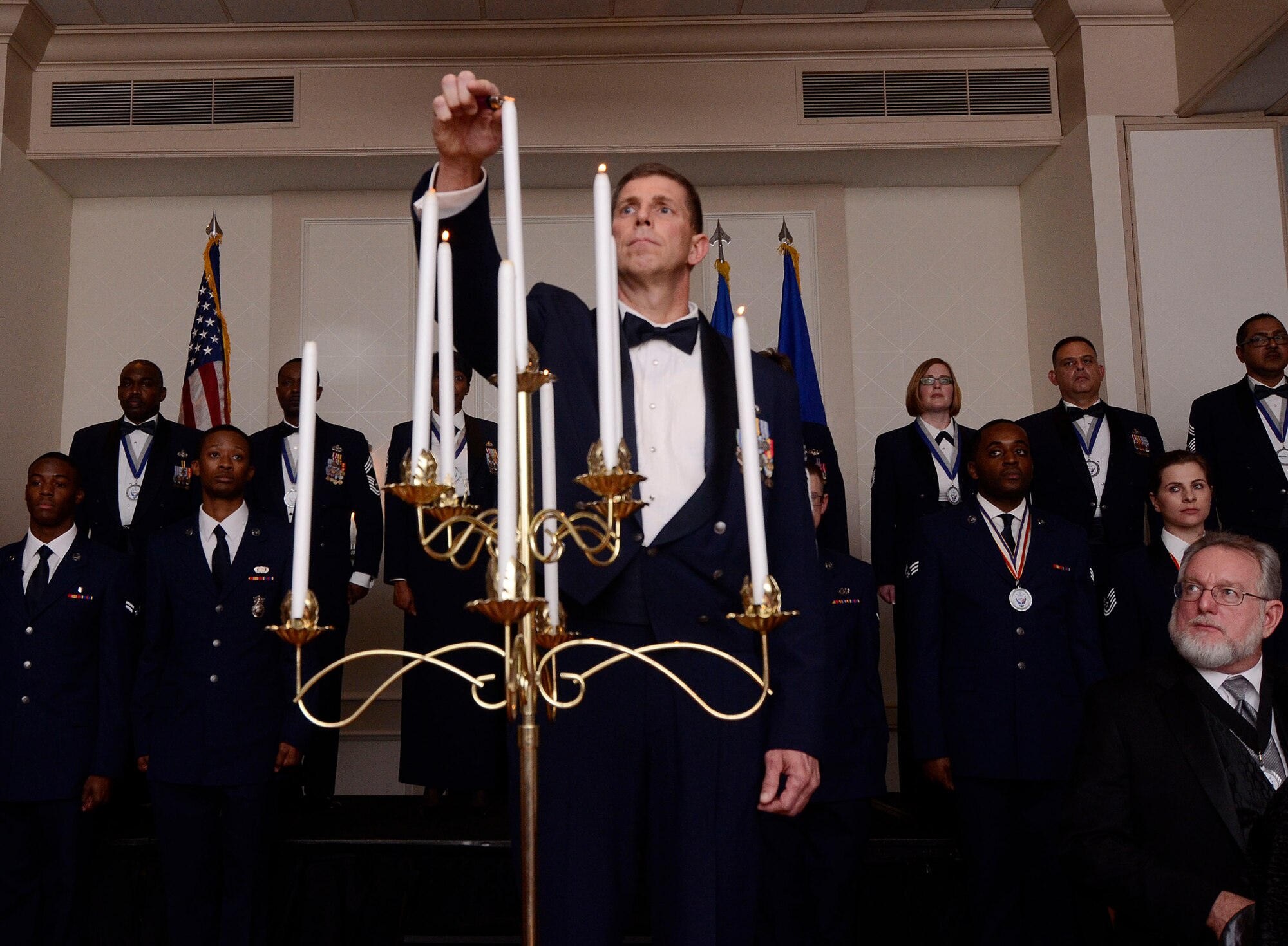 Lighting of the ninth candle is performed by a Chief Master Sgt., symbolizing the acceptance of selection to the highest enlisted grade. The Candle Lighting portion of the ceremony, honoring the newest Chief Master Sergeants, was held during the First Annual Dobbins Recognition Ceremony in Marietta, Ga. 7 Feb., 2015. The ceremony recognized individuals who demonstrated the capability to excel, and present themselves as the best of 2014.  (U.S. Air Force photo/Don Peek)