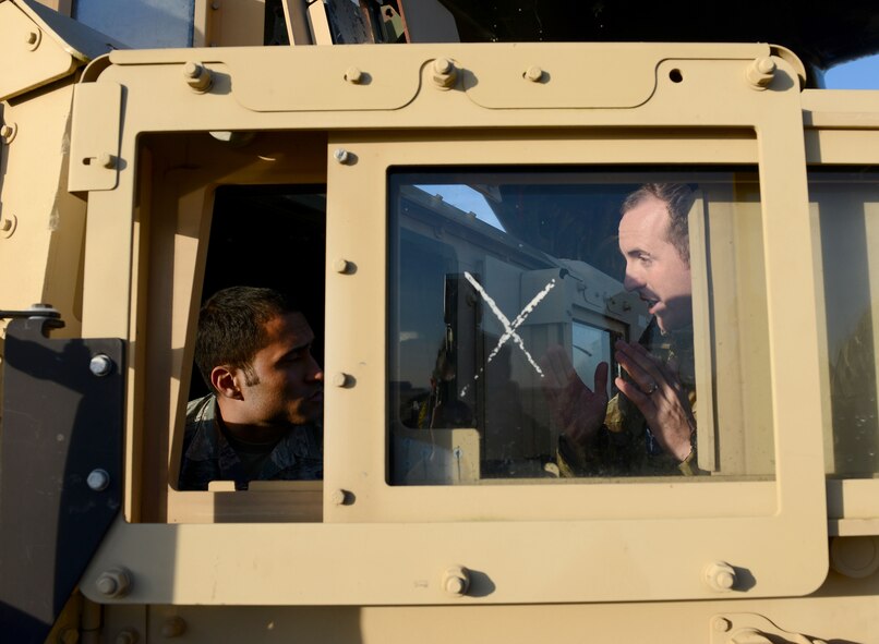 U.S. Air Force Senior Airman John Paul Anes, left, 352nd Special Operations Support Squadron deployed aircraft ground response element member from Aguadilla, Puerto Rico, discusses loading a Humvee into a Royal Air Force C-130J Super Hercules with RAF Senior Aircraftsman Oliver Parsons, right, Joint Air Delivery trials and evaluations unit member, during training Jan. 20, 2015, on RAF Mildenhall, England. Members of the RAF worked with members of the 352nd SOSS DAGRE team to practice loading and unloading the Humvee in preparation for their upcoming joint training exercise, Emerald Warrior, held at Hurlburt Field, Fla. (U.S. Air Force photo by Senior Airman Kate Maurer/Released)