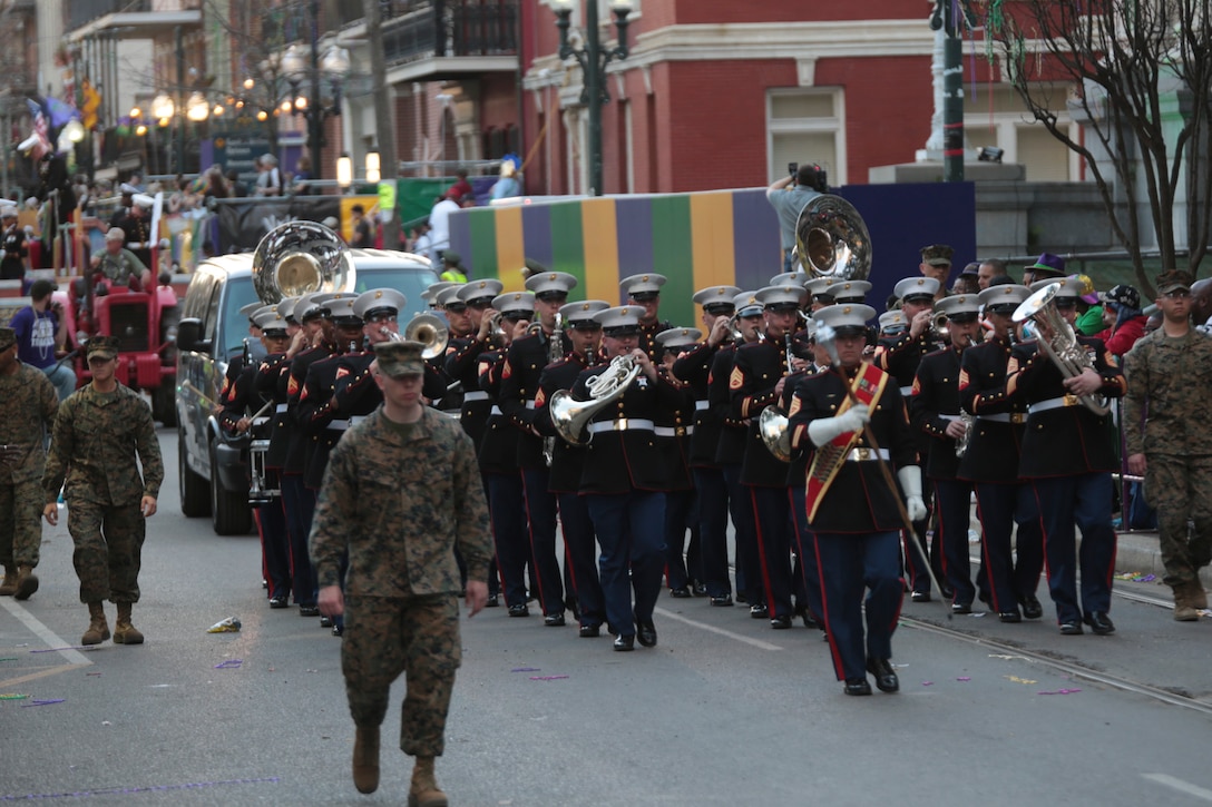 Marine Corps Band New Orleans marches with the Legion of Mars group during the Krewe of Alla Mardi Gras parade in New Orleans, Feb. 8, 2015. The group was invited to be guest members of the parade for the second year in a row with several floats recognizing all branches and wounded veterans. Every year Marine Corps Band New Orleans performs in many different Mardi Gras parades to show military presence and support to the New Orleans community. (U.S. Marine Corps photo by Lance Cpl. Ian Ferro)