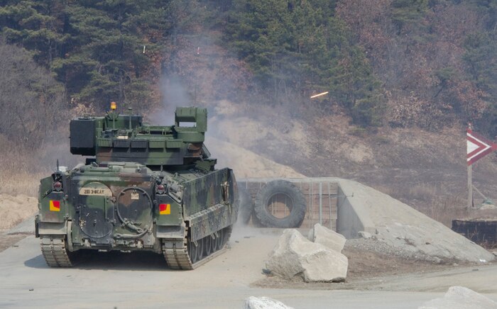RODRIGUEZ LIVE FIRE COMPLEX, South Korea (Feb. 5, 2015) - A Bradley Fighting Vehicle, from B Company, 3rd Squadron, 8th Cavalry Regiment, 3rd Brigade Combat Team, 1st Cavalry Division, fires its main gun at targets at Rodriguez Live Fire Complex. Bradley and M1A2 Abrams tank crews from 3-8 Cav. conducted gunnery skills training to ensure unit readiness before rotating out this summer. 