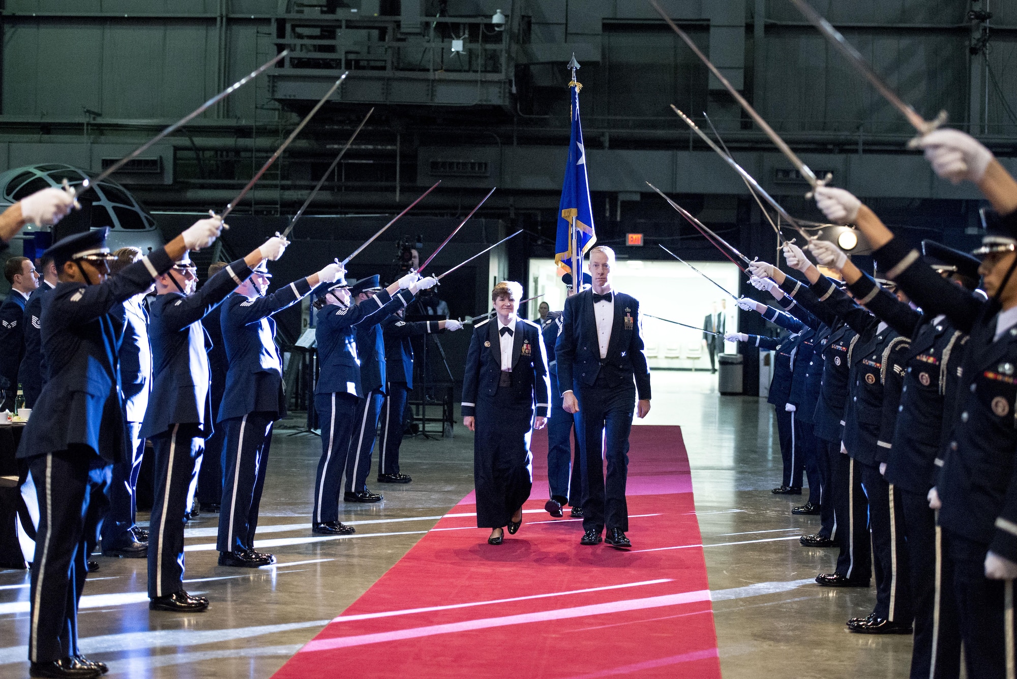 Gen. Janet Wolfenbarger is joined by Chief Master Sgt. Michael Warner as she enters her Order of the Sword induction ceremony through a formation of sabers raised by an Honor Guard Feb. 5, 2015, at the National Museum of the U.S. Air Force in Ohio. The ceremony was steeped in medieval symbolism and military tradition, and paid tribute to the general's servant leadership. The Order of the Sword is the highest honor Air Force NCOs can bestow upon an individual who has made significant contributions to the enlisted force. Wolfenbarger is the Air Force Materiel Command commander and Warner is the AFMC command chief. (U.S. Air Force photo/Wesley Farnsworth)