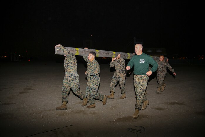 Marines of Support Battalion work together to carry a log during the log race at Marine Corps Recruit Depot San Diego, Jan. 21.  Marines utilized mental strength, one of the key elements taught during recruit training, to help them give their all throughout 