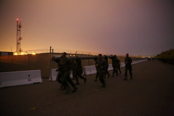 Marines of Support Battalion run with a log while some wait to rotate back in during the log race at Marine Corps Recruit Depot San Diego, Jan. 21.  Each team used their physical and mental strength to push their minds past the exhaustion and pain of carrying the 150 to 200 pound logs.  