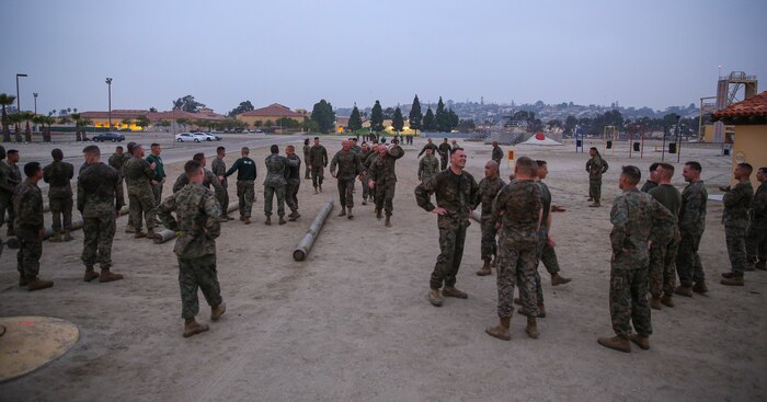 Marines of Support Battalion take a much needed breather after finishing the three-mile log race at Marine Corps Recruit Depot San Diego, Jan. 21.  The celebrations were shortly lived as those team that finished early set their logs down and quickly ran back out in the course to help push the teams still running.