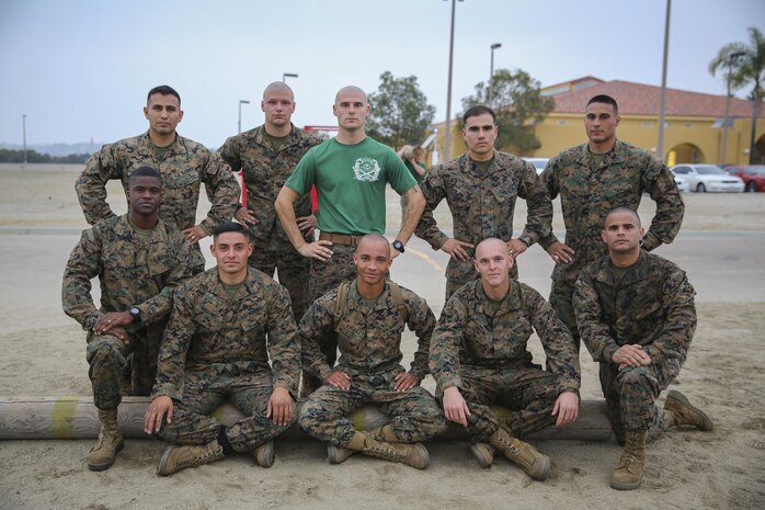 Marines of Support Battalion, in the winning team of the log race event, come together after completing the log race at Marine Corps Recruit Depot San Diego, Jan. 21.  Finishing first earned the team a challenge coin, Letter of Appreciation and a 72-hour liberty pass.