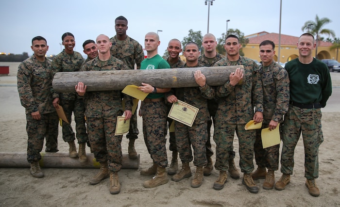 The team of Marines from Support Battalion that won the log race event hold their trophy log after completing the log race at Marine Corps Recruit Depot San Diego, Jan. 21.  Finishing first earned the team a challenge coin, Letter of Appreciation and a 72-hour liberty pass.