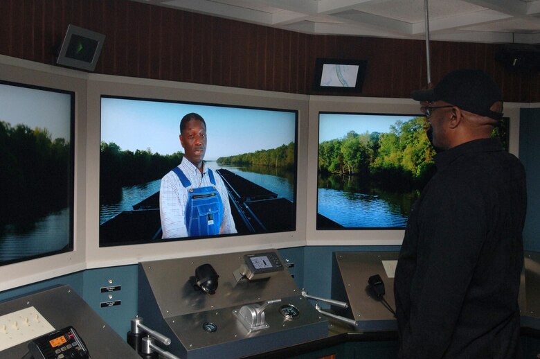 Eddy Scott interacts with a tugboat captain at the Tennessee-Tombigbee Waterway Transportation Museum just after its dedication in Columbus, Miss., Feb. 6, 2015.