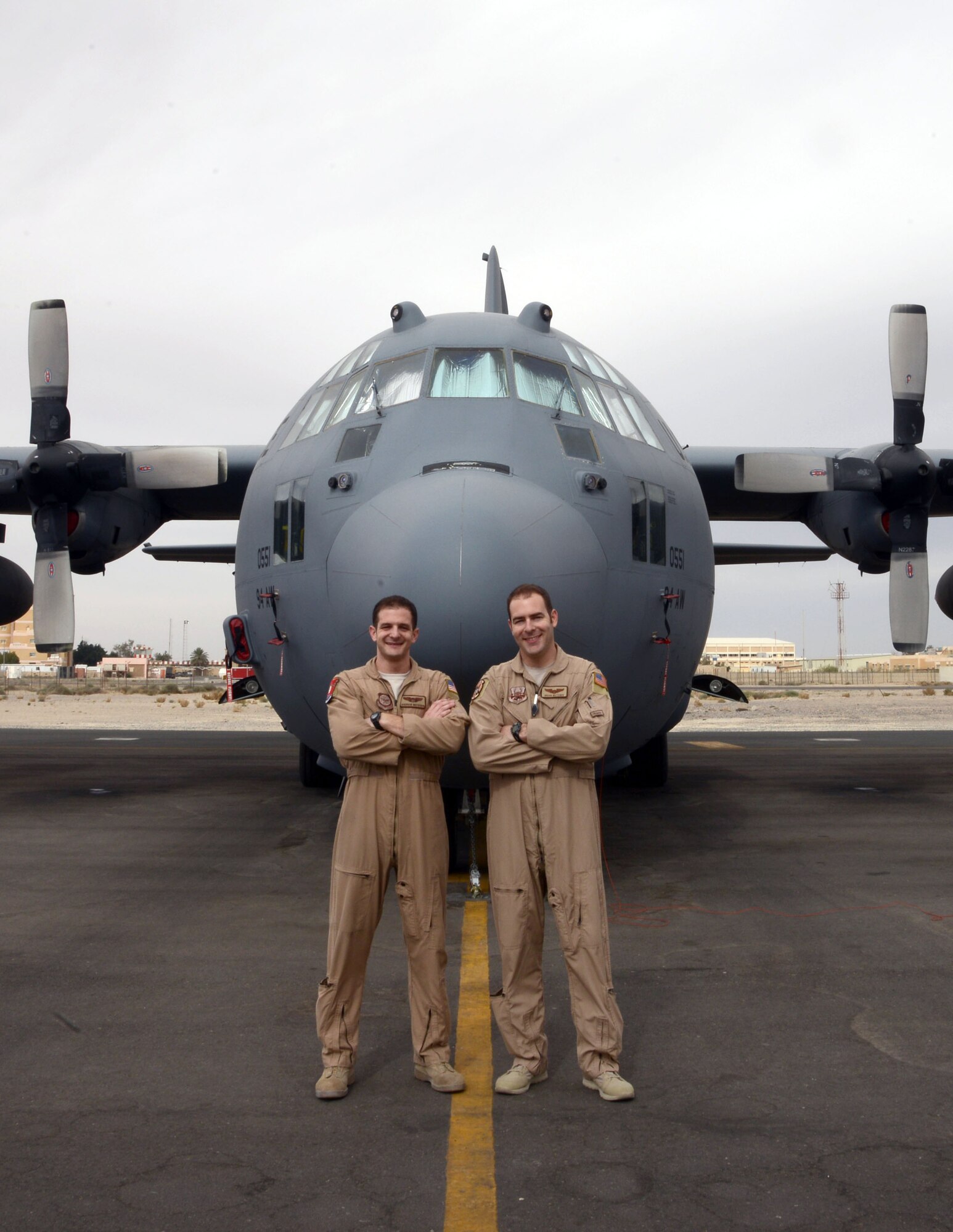 Capt. Andrew Metzger (left) stands with his brother Capt. Andrew Metzger in front of a C-130H here Feb. 7, 2015.  Andrew is a C-17 pilot stationed at Charleston Air Force Base, South Carolina, and Brian is an Air Force Reserve C-130 Hercules pilot deployed from Dobbins Air Reserve Base, Georgia.  (U.S. Air Force photo by 1st Lt. Sarah Ruckriegle)