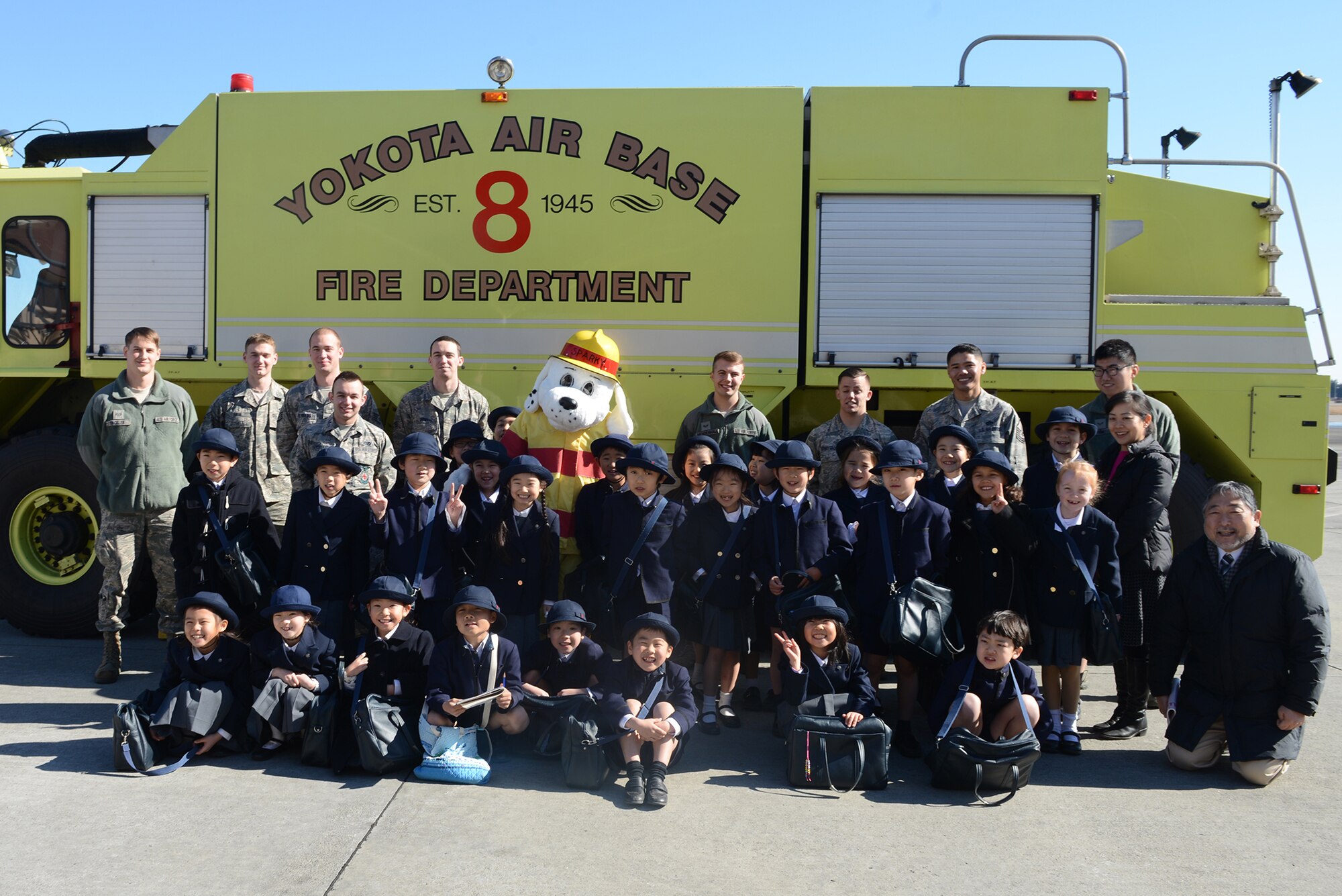 Keimei Gakuen students pose for a group photo with Airmen from the 374th Civil Engineer Squadron after a tour of 374 CES facilities at Yokota Air Base, Japan, Feb. 3, 2015. The tour was used to strengthen relations with the local community. (U.S. Air Force photo by Airman 1st Class David C. Danford/Released)
