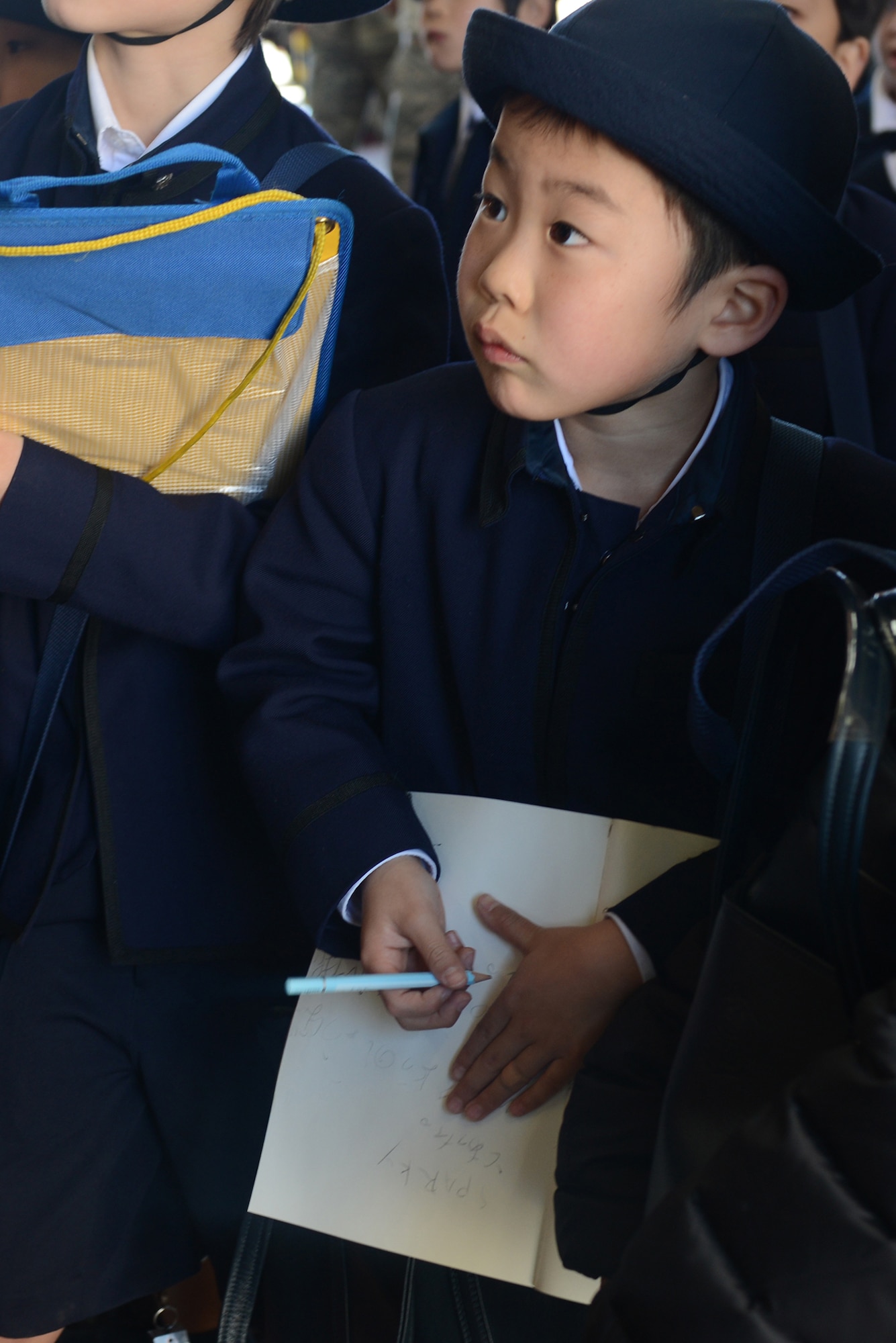 A student from Keimei Gakuen takes notes during a tour of 374th Civil Engineer Squadron facilities at Yokota Air Base, Japan, Feb. 3, 2015. The tour was used to strengthen relations with the local community. (U.S. Air Force photo by Airman 1st Class David C. Danford/Released)