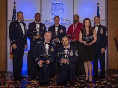 Col. John Lamontagne, 437th Airlift Wing commander, and Chief Master Sgt. Shawn Hughes, 437th AW command chief, recognize the annual award winners at the 2014 437th Airlift Wing Annual Awards ceremony held Feb. 6, 2015. The annual award winners are: Airman of the year, Senior Airman Stephanie A. Lucas, Noncommissioned Officer of the year, Tech. Sgt. Chelce T. Green, First Sergeant of the year, Master Sgt. Mark O’Brien, Senior Noncommissioned Officer of the year, Senior Master Sgt. Bryan T. Whitley, Company Grade Officer of the year, Capt. Daniel A. Naske, Civilian Cat I of the year, Virgil Parks, Civilian Cat II of the year, Gary Wettengel, Key Spouse of year, Molly F.B. Wood. (U.S. Air Force photo/ Senior Airman Dennis Sloan)