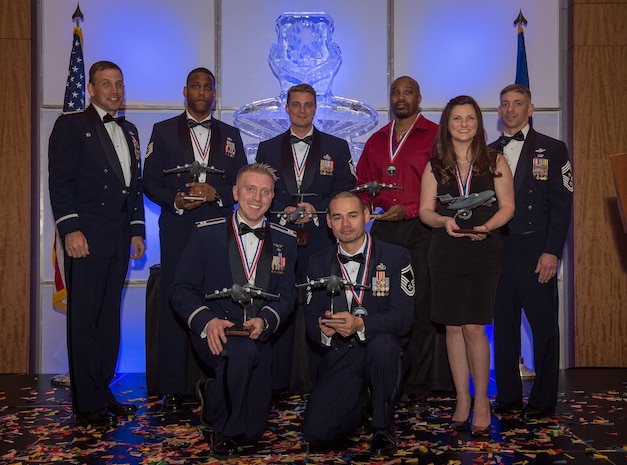 Col. John Lamontagne, 437th Airlift Wing commander, and Chief Master Sgt. Shawn Hughes, 437th AW command chief, recognize the annual award winners at the 2014 437th Airlift Wing Annual Awards ceremony held Feb. 6, 2015. The annual award winners are: Airman of the year, Senior Airman Stephanie A. Lucas, Noncommissioned Officer of the year, Tech. Sgt. Chelce T. Green, First Sergeant of the year, Master Sgt. Mark O’Brien, Senior Noncommissioned Officer of the year, Senior Master Sgt. Bryan T. Whitley, Company Grade Officer of the year, Capt. Daniel A. Naske, Civilian Cat I of the year, Virgil Parks, Civilian Cat II of the year, Gary Wettengel, Key Spouse of year, Molly F.B. Wood. (U.S. Air Force photo/ Senior Airman Dennis Sloan)