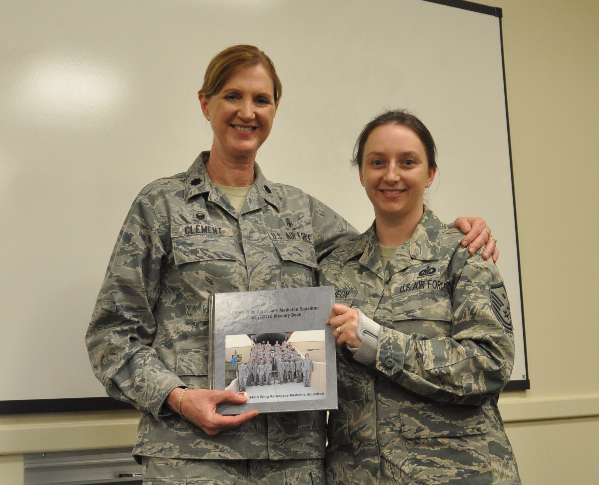 Lt. Col. Julie M. Clement, 940th Aerospace Medicine Squadron commander (left), is presented with a memento from her first sergeant, Master Sgt. Christina McCutcheon, at her luncheon, Feb. 7, at Beale Air Force Base, Calif. As the 940th AMDS commander for the past four years, Clement's been responsible for the medical readiness of more than 1,100 personnel.