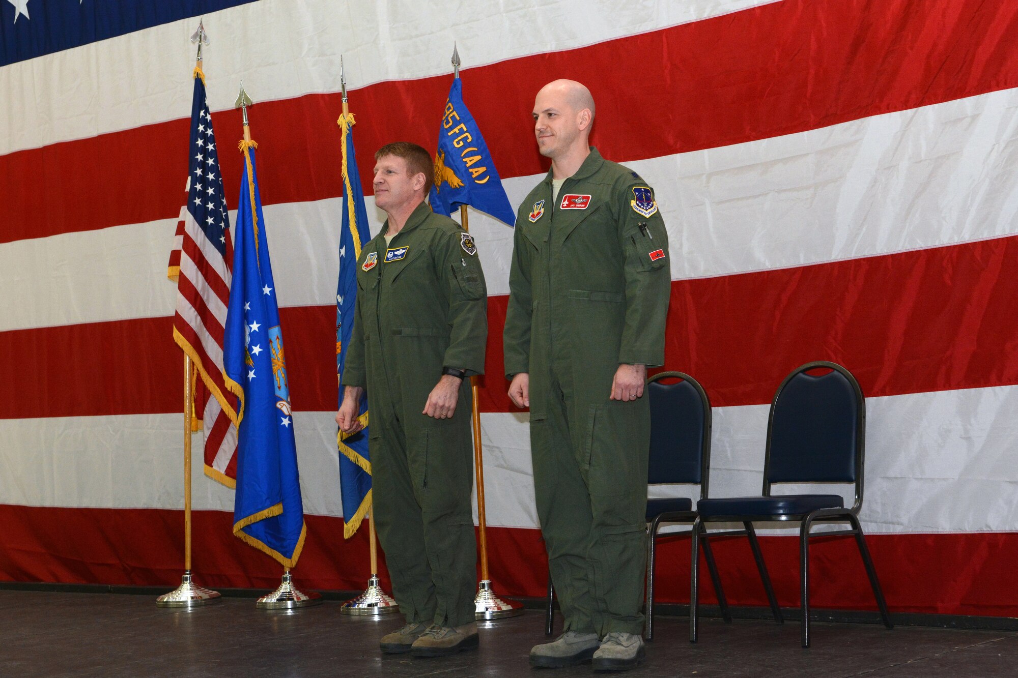 Lt. Col. J. Scott Gibson, commander of the 495th Fighter Group’s Detachment 176, and Col. James D. McCune, 495th Fighter Group commander, stand in front of a crowd of Airmen during an assumption of command ceremony in Hangar 406 on Truax Field, Madison, Wis., Feb. 7, 2015. Gibson will ultimately be responsible for 40 active duty personnel and four pilots at the 115th Fighter Wing as part of the Air Force’s total force integration, a program designed to integrate active duty and guard Airmen. (U.S. Air National Guard photo by Senior Airman Andrea F. Rhode)