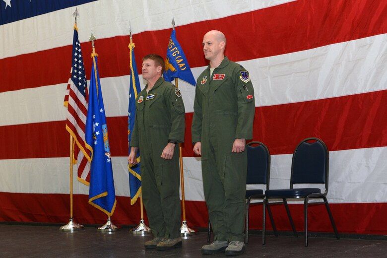 Lt. Col. J. Scott Gibson, commander of the 495th Fighter Group’s Detachment 176, and Col. James D. McCune, 495th Fighter Group commander, stand in front of a crowd of Airmen during an assumption of command ceremony in Hangar 406 on Truax Field, Madison, Wis., Feb. 7, 2015. Gibson will ultimately be responsible for 40 active duty personnel and four pilots at the 115th Fighter Wing as part of the Air Force’s total force integration, a program designed to integrate active duty and guard Airmen. (U.S. Air National Guard photo by Senior Airman Andrea F. Rhode)