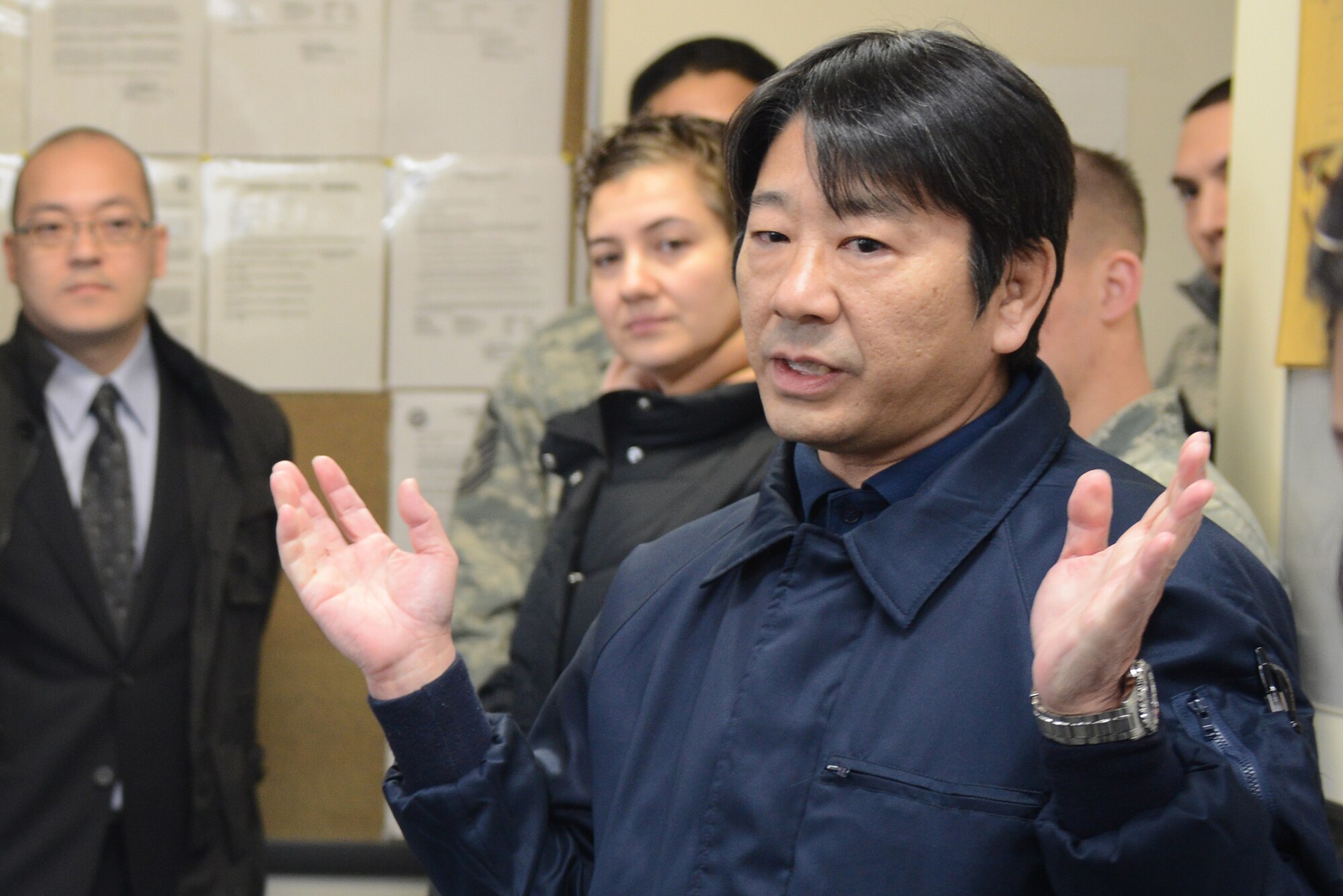 Yoshihiro Takayama, 374th Civil Engineer Squadron boiler plant foreman, briefs students from the Keimei Gakuen at Yokota Air Base, Japan, Feb. 3, 2015. The boiler plant was the first 374 CES facility the students visited during the tour. (U.S. Air Force photo by Airman 1st Class David C. Danford/Released)