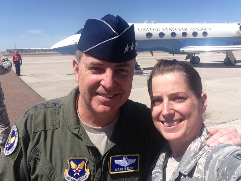 Senior Airman Michelle Collins, 341st Missile Wing protocol assistant, poses with Air Force Chief of Staff Gen. Mark A. Welsh III during a 2014 visit to Malmstrom Air Force Base, Mont. Founded on ceremonial etiquette, deep-rooted military customs and courtesies and long-honored traditions, protocol officials require great attention to detail, excellent communication and superb organizational skills. (U.S. Air Force/Senior Airman Michelle Collins) 
