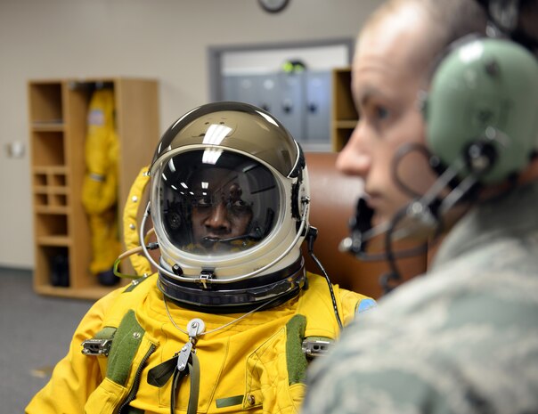 Senior Airman Garret McNeely (right), 9th Physiological Support Squadron aerospace physiology technician, performs a maintenance check on a full pressure suit worn by Lt. Col. Merryl Tengesdal, 9th Reconnaissance Wing inspector general and U-2 Dragon Lady pilot Feb. 9, 2015. Tengesdal is the only black female U-2 pilot in history. (U.S. Air Force photo by Senior Airman Bobby Cummings/Released)