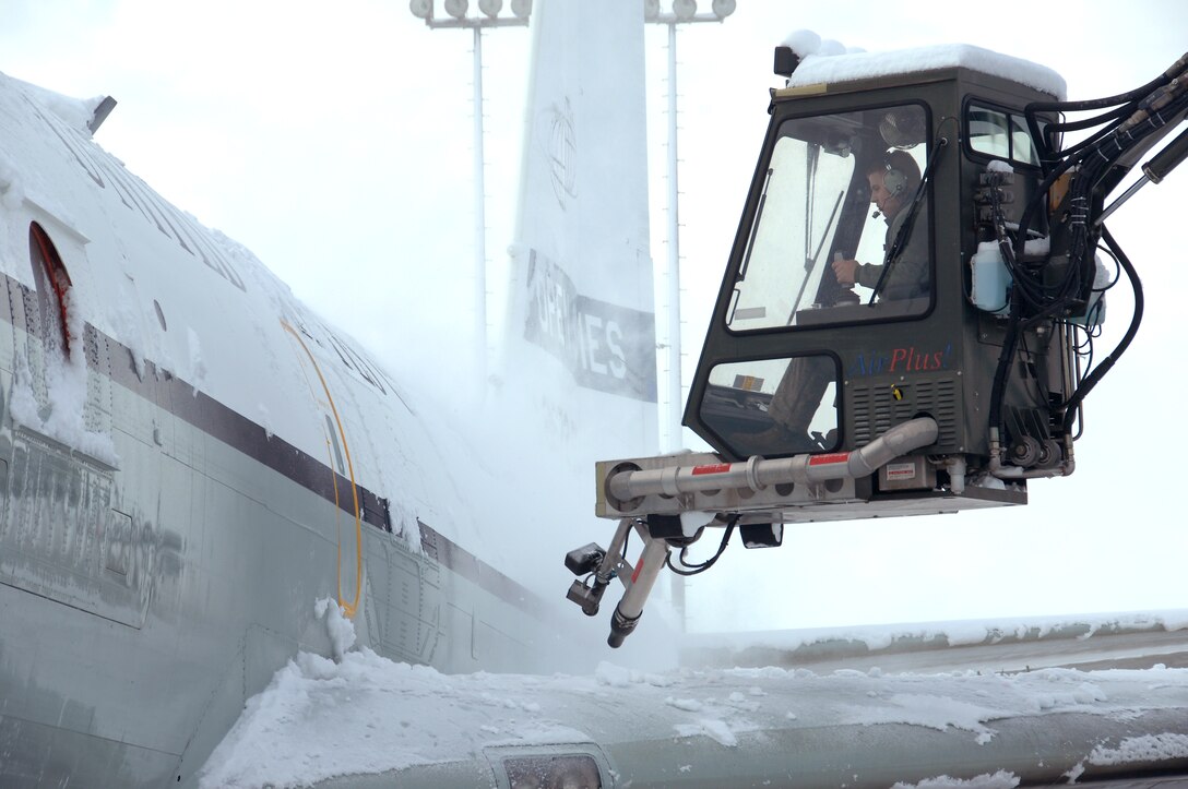 U.S. Air Force Senior Airman Riley Neads operates an air cannon from a deicing truck to blow snow off of the wing of an OC-135 Open Skies aircraft Feb. 3 at Offutt Air Force Base Neb. Additional maintenance time is typically needed during winter operations to heat the aircraft and to remove snow and ice. Neads is a crew chief assigned to the 83rd Aircraft Maintenance Unit, 55 Aircraft Maintenance Squadron. (U.S. Air Force photo by Delanie Stafford/Released)