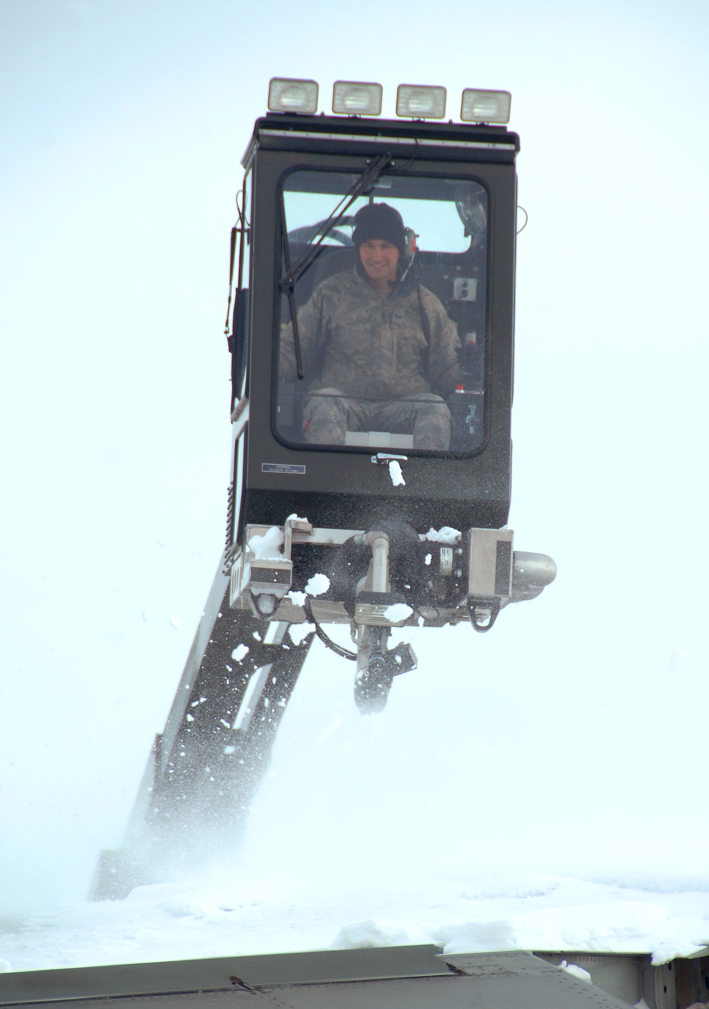 U.S. Air Force Senior Airman Kyle Kindig operates an air cannon from a deicing truck to blow snow off the wing of an OC-135 Open Skies aircraft Feb. 3 at Offutt Air Force Base Neb. Additional maintenance time is typically needed during winter operations to heat the aircraft and to remove snow and ice. Kindig is a guidance and control maintenance technician assigned to the 83rd Aircraft Maintenance Unit, 55 Aircraft Maintenance Squadron. (U.S. Air Force photo by Delanie Stafford/Released)