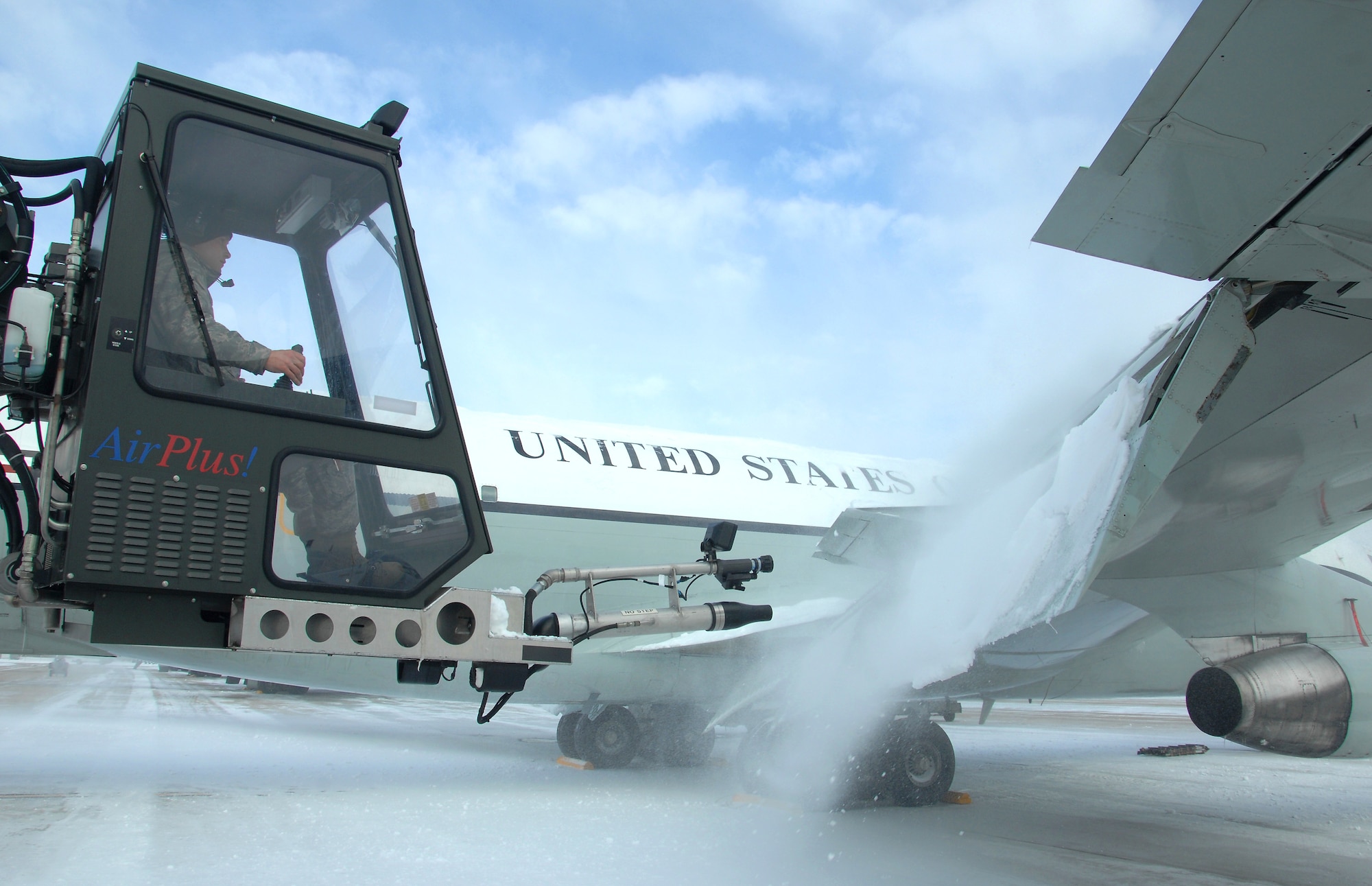 U.S. Air Force Senior Airman Kyle Kindig operates an air cannon from a deicing truck to blow snow off the wing of an OC-135 Open Skies aircraft Feb. 3 at Offutt Air Force Base Neb. Additional maintenance time is typically needed during winter operations to heat the aircraft and to remove snow and ice. Kindig is a guidance and control maintenance technician assigned to the 83rd Aircraft Maintenance Unit, 55 Aircraft Maintenance Squadron. (U.S. Air Force photo by Delanie Stafford/Released)