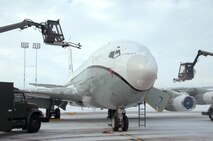 U.S. Air Force Senior Airman Kyle Kindig, left, and U.S. Air Force Senior Airman Riley Neads, right, operate air cannons from deicing trucks to blow snow off of an OC-135 Open Skies aircraft Feb. 3 at Offutt Air Force Base Neb. Additional maintenance time is typically needed during winter operations to heat the aircraft and to remove snow and ice. Kindig and Neads are assigned to the 83rd Aircraft Maintenance Unit, 55 Aircraft Maintenance Squadron. (U.S. Air Force photo by Delanie Stafford/Released)