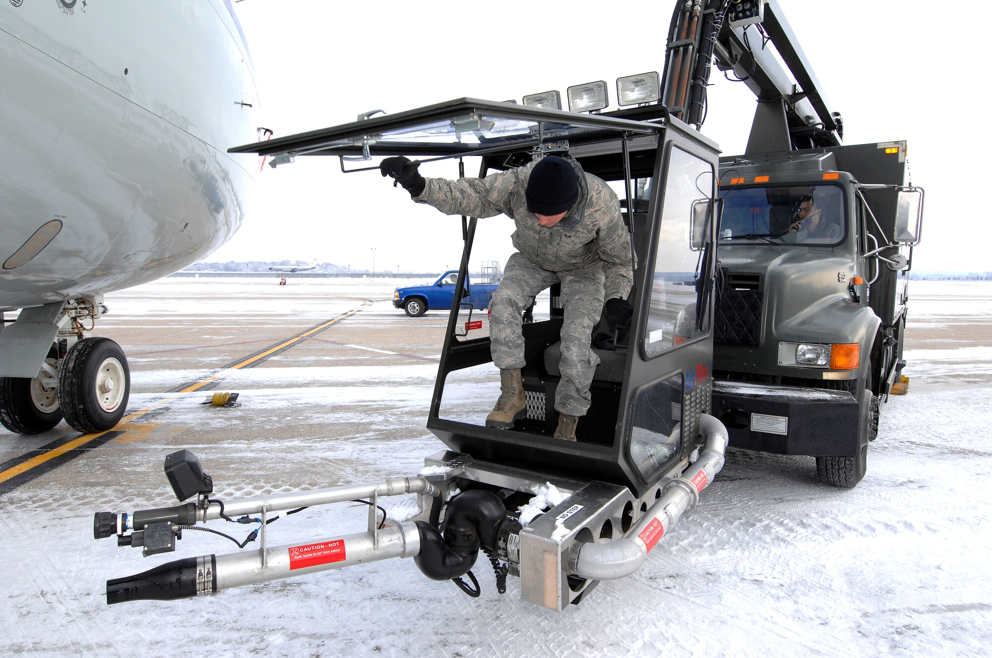U.S. Air Force Senior Airman Kyle Kindig climbs into the bucket of a deicing truck boom Feb. 3 at Offutt Air Force Base Neb. The equipment is used to blow accumulated snow off of aircraft and to spray a deicing fluid as part of preparations for an aircraft takeoff during colder weather. Additional maintenance time is typically needed during winter operations to heat the aircraft and to remove snow and ice.  Kindig is a guidance and control maintenance technician assigned to the 83rd Aircraft Maintenance Unit, 55 Aircraft Maintenance Squadron. (U.S. Air Force photo by Delanie Stafford/Released)