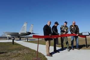 U.S. Air Force Col. Kevin Huyck, 1st Fighter Wing commander, retired Col. Michael Frankel, retired Col. Jim Hardenbrook and retired Col. Pete Marty, members of the 1st Fighter Association, cut a ribbon during the F-15 Eagle dedication ceremony, Feb. 6, 2015, at Langley Air Force Base, Va. The F-15, tail number 0055, represents 34 years of Eagle history at Langley. (U.S. Air Force photo by Staff Sgt. Stephanie R. Plichta/Released)