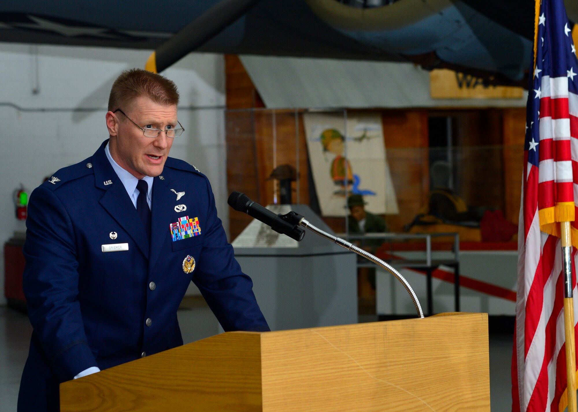 Col. Michael Grismer, 436th Airlift Wing commander, offers closing remarks concluding the 2015 Honorary Commander Induction Ceremony Feb. 7, 2015, at the Air Mobility Command Museum, Del. The Air Force developed the Honorary Commander Program to immerse community leaders in Air Force culture and its missions, customs and traditions. (U.S. Air Force photo/Airman 1st Class William Johnson)
