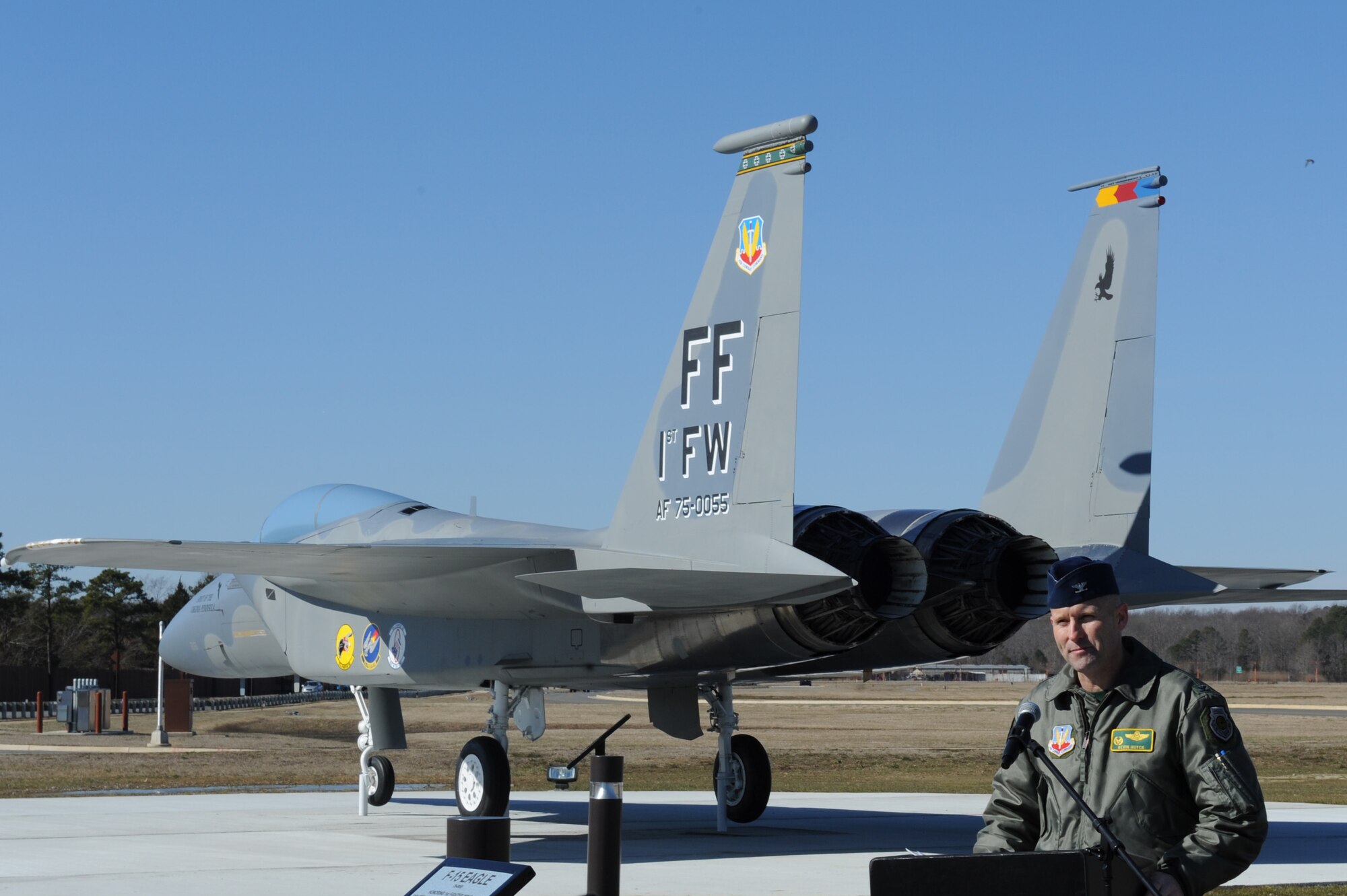 U.S. Air Force Col. Kevin Huyck, 1st Fighter Wing commander, welcomes honored guests and Airmen to the F-15 Eagle dedication ceremony, Feb. 6, 2015, at Langley Air Force Base, Va. The F-15 Eagle is a significant part of the 1st Fighter Wing’s history as it was used to intercept Soviet TU-95 reconnaissance aircraft during sea trails of the USS Vinson. (U.S. Air Force photo by Staff Sgt. Stephanie R. Plichta/Released)