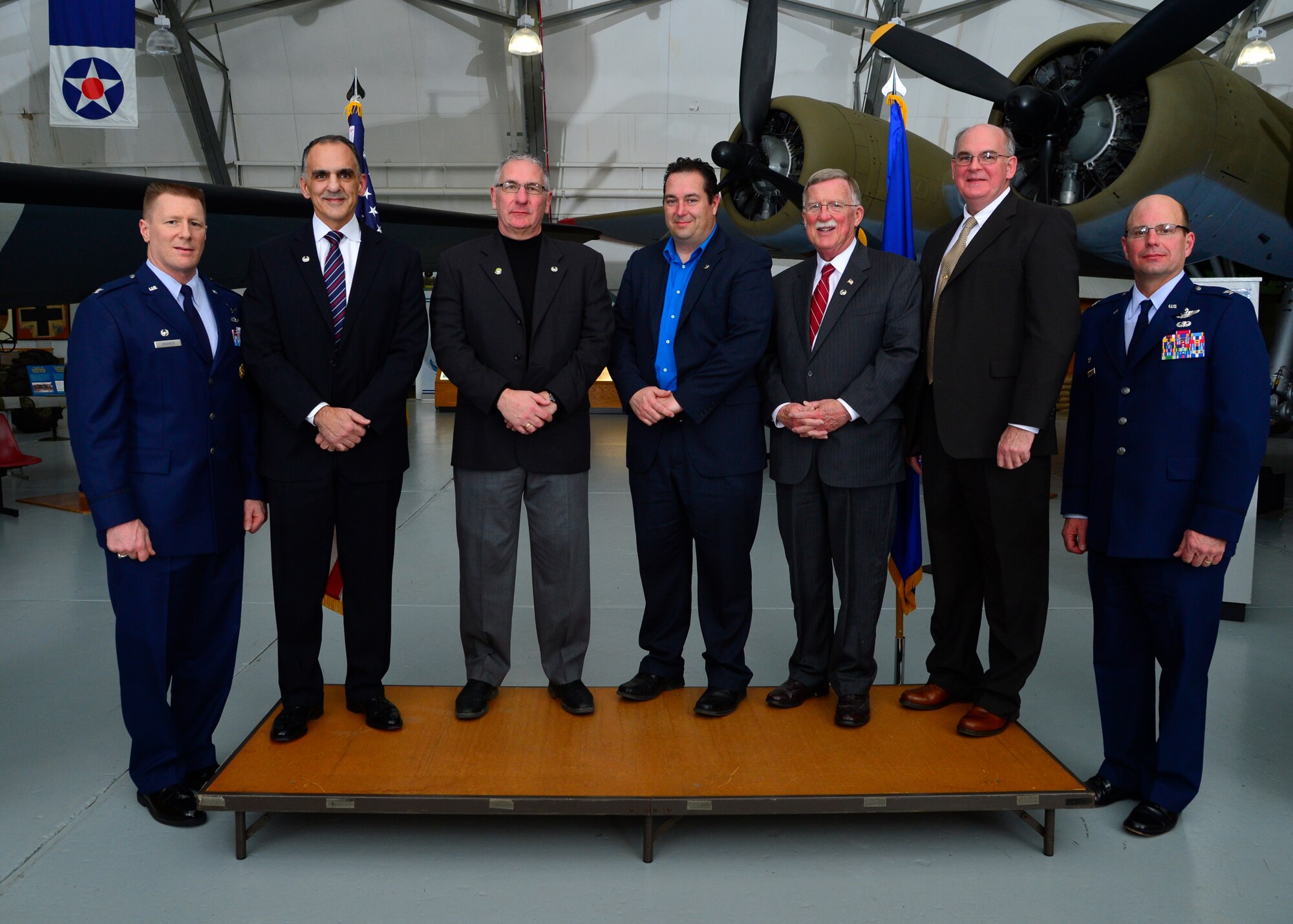 Col. Michael Grismer, left, 436th Airlift Wing commander and Col. Raymond Kozak, right, 512th Airlift Wing commander, pose for photo with new inductees into the Honorary Commander Alumni Association during the 2015 Honorary Commander Induction Ceremony Feb. 7, 2015, at the Air Mobility Command Museum, Del. The HCAA supports the current program, as well as maintains and fosters relationships with military leaders. (U.S. Air Force photo/Airman 1st Class William Johnson)