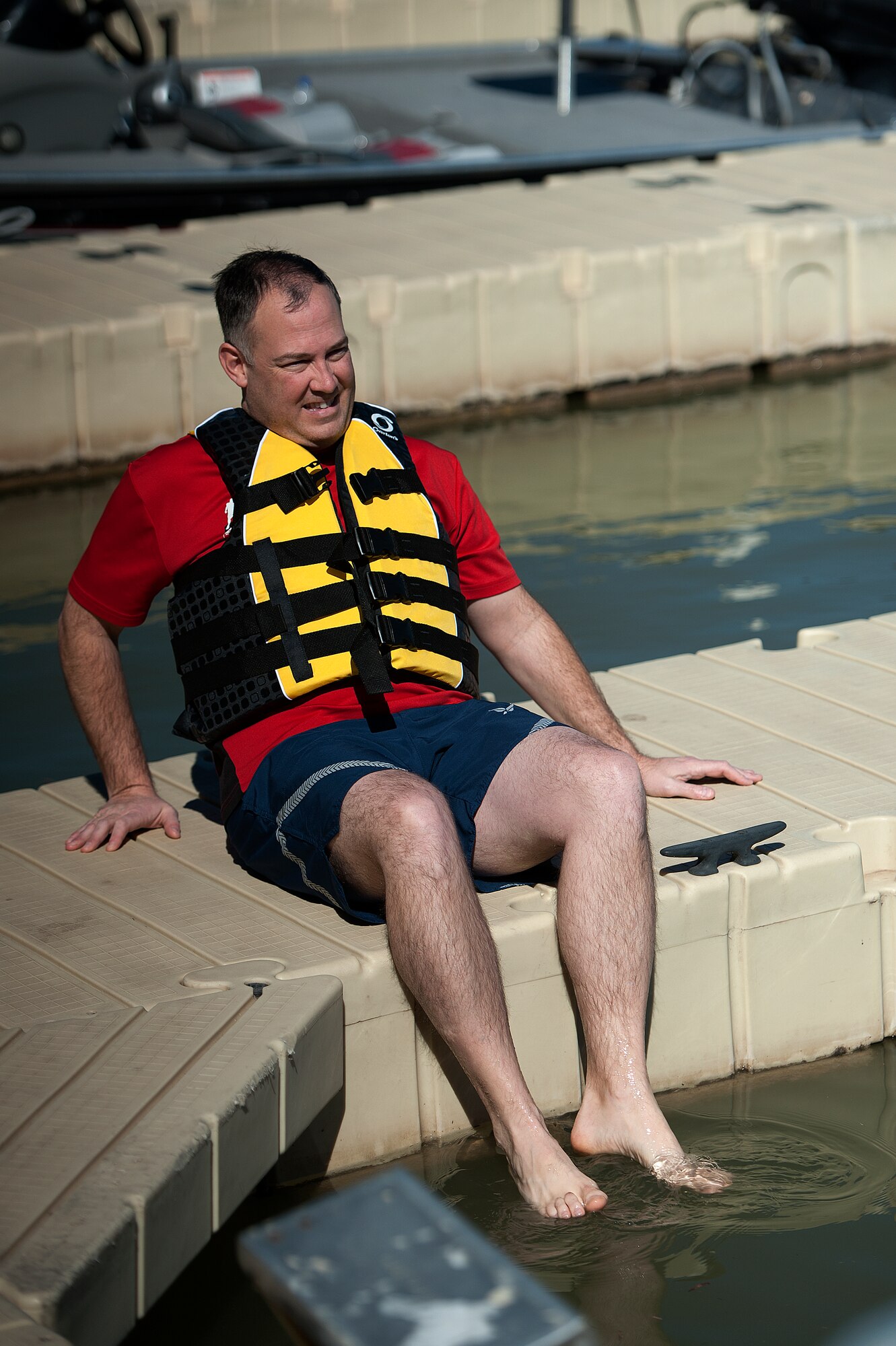 SAN ANGELO, Texas – Lt. Col. Gregory J. Scougall, 17th Mission Support Group Deputy Commander, dips his feet in Lake Nasworthy during the 13th Annual Polar Bear Swim at the Goodfellow Recreation Camp Feb. 7. The water got as low as 30 degrees Fahrenheit for the event. (U.S. Air Force photo/ Airman 1st Class Devin Boyer)