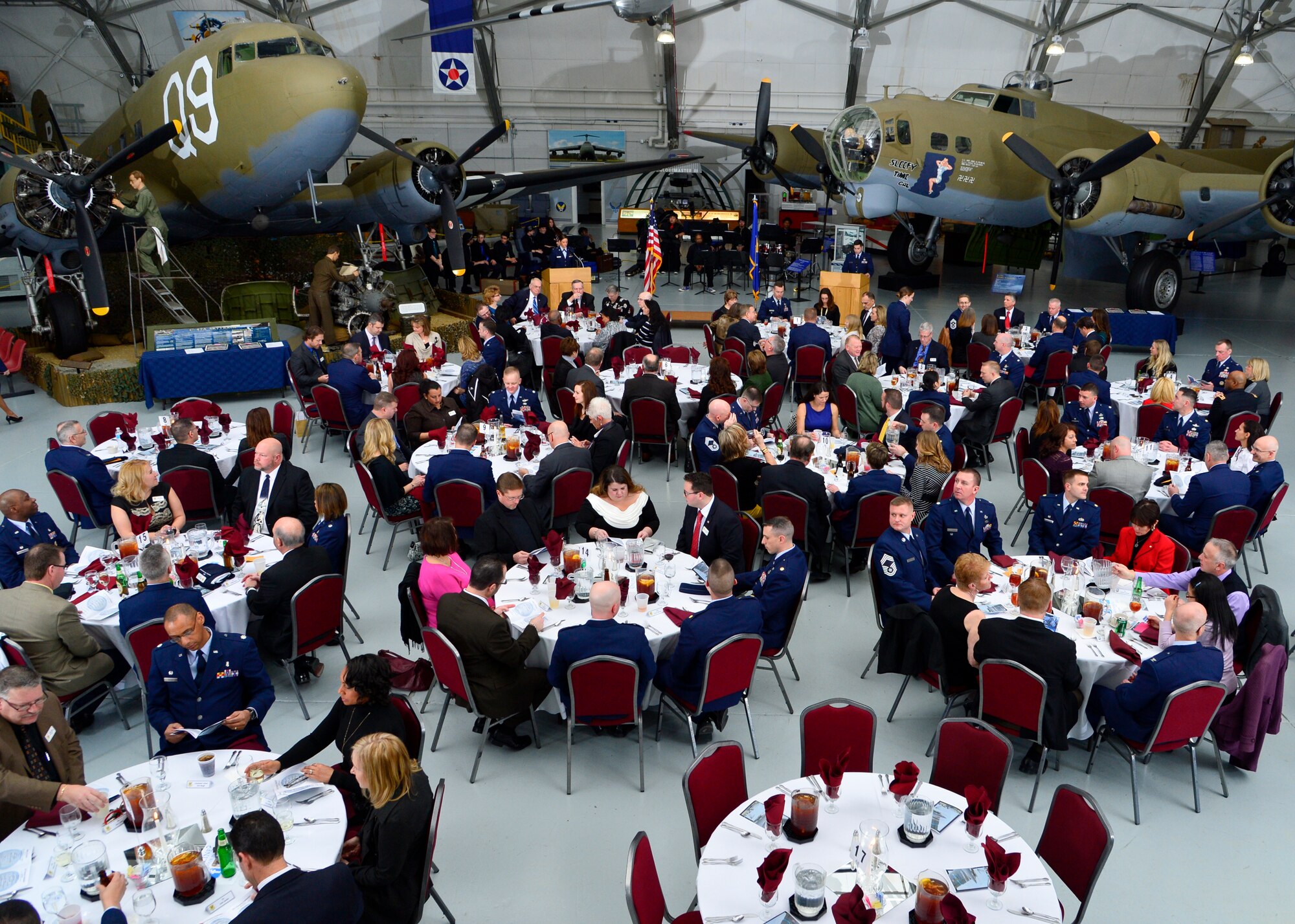 Attendees of 2015 Honorary Commander Induction Ceremony review the evening’s program  prior to the start of the event Feb. 7, 2015, at the Air Mobility Command Museum, Del. The Honorary Commander Program first began at Dover AFB in 1992 and matches civic-leaders with active duty and reserve military commanders. (U.S. Air Force photo/Airman 1st Class William Johnson)