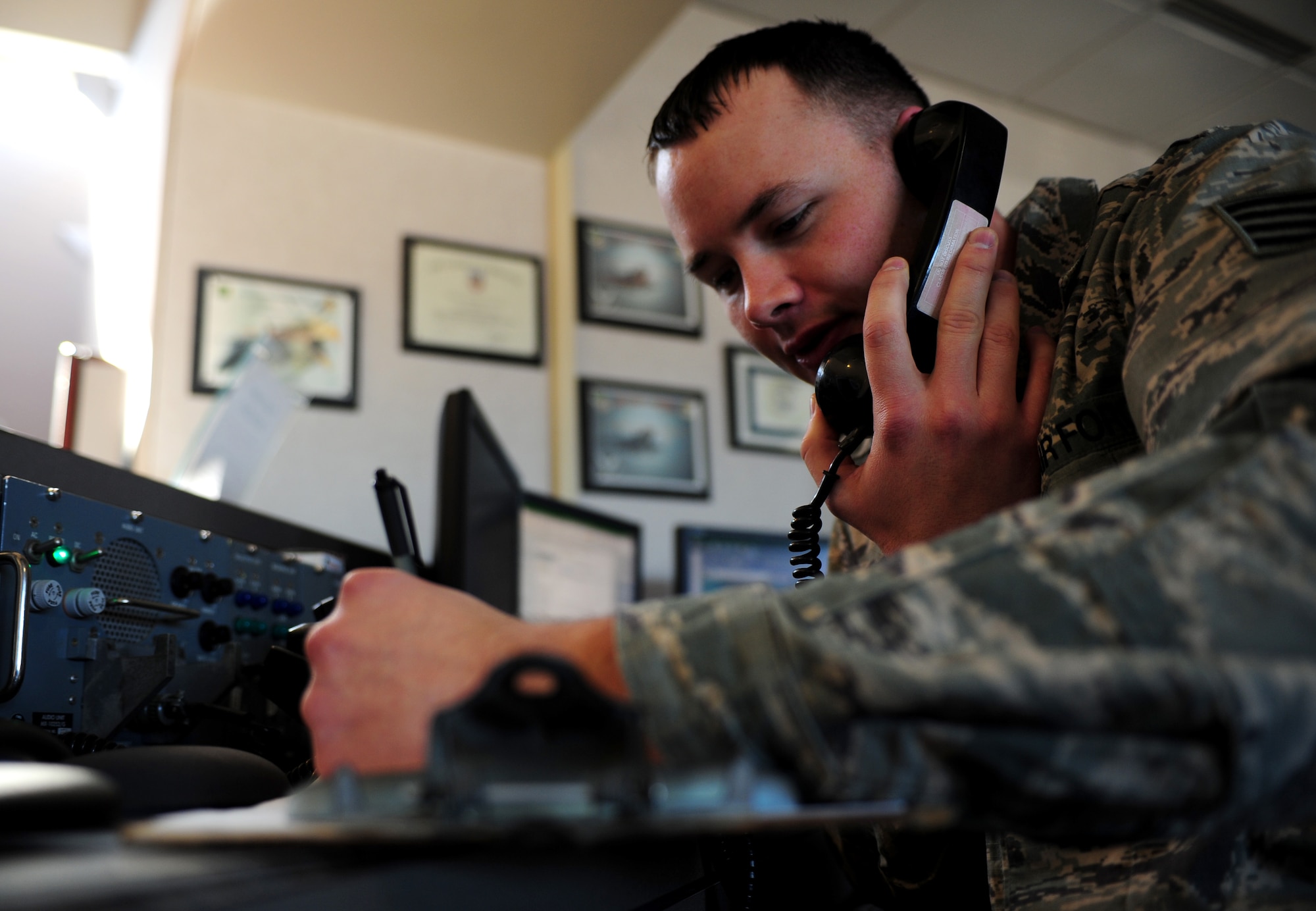 U.S. Air Force Staff Sgt. Paul Smith, 1st Operations Support Squadron weather apprentice, speaks to a pilot in flight at Langley Air Force  Base, Va., Feb. 6, 2015. Weather personnel use pilot-to-meteorologist services to contact pilots while in the air to relay weather conditions. (U.S. Air Force photo by Airman 1st Class Areca T. Wilson/Released) 