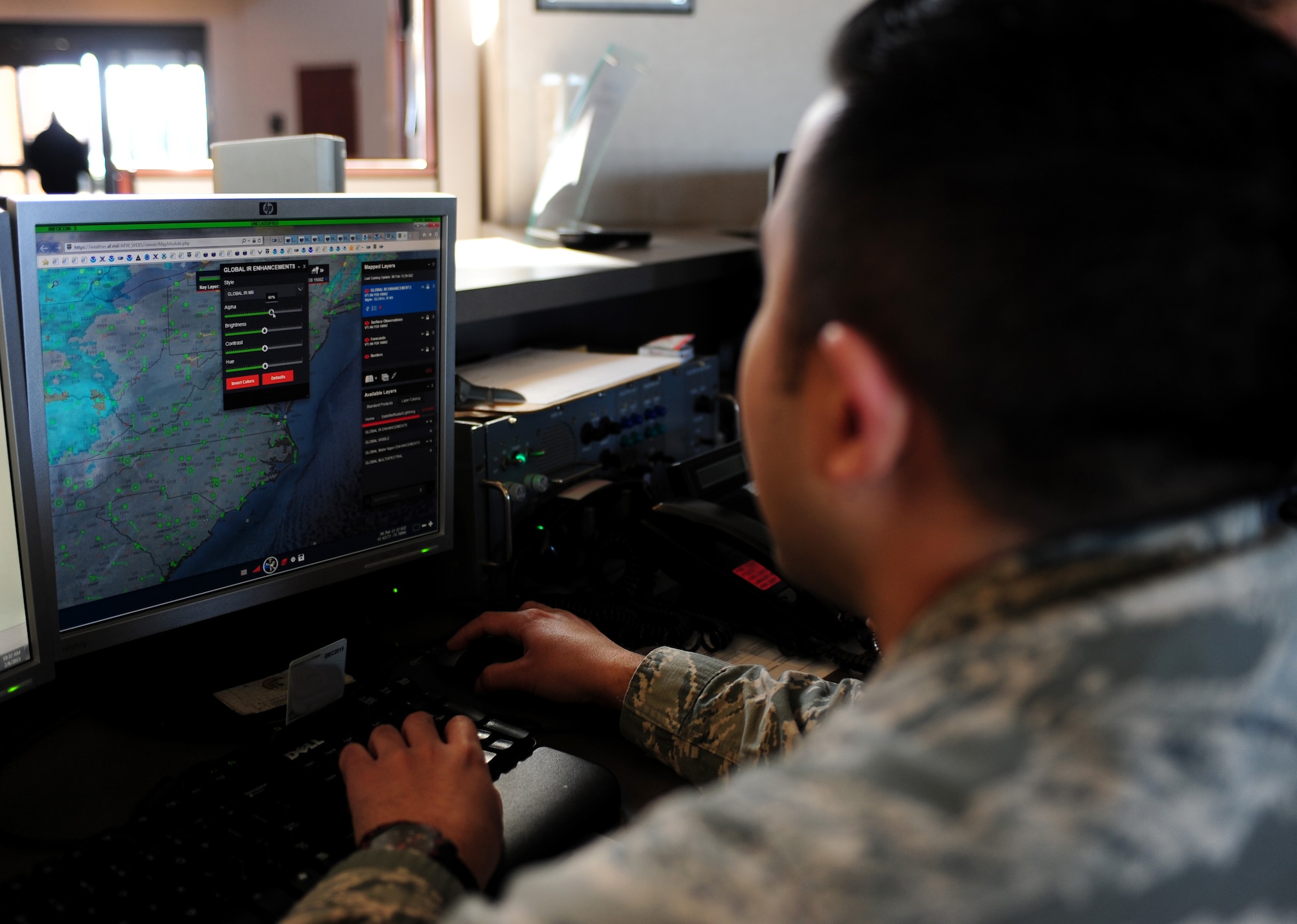 U.S. Air Force Staff Sgt. Adam Ybarra, 1st Operations Support Squadron weather forecaster, analyzes surface observations ahead of an oncoming low pressure system at Langley Air Force  Base, Va., Feb. 6, 2015. To help ensure the safety of the base’s population, weather personnel prepare forecasts and issue up-to-date weather warnings during hazardous conditions. (U.S. Air Force photo by Airman 1st Class Areca T. Wilson/Released)