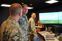U.S. Air Force Master Sgt. Thomas Cohee, 55th Operations Support Squadron assistant chief controller, gives U.S. Maj. Gen. John N.T. Shanahan, 25th Air Force commander, a briefing inside the air traffic control tower on Offutt Air Force Base, Neb., Jan. 27. Shanahan visited several facilities, met with multiple Airmen and held an all-call during his visit to Offutt. (U.S. Air Force photo by Charles Haymond/Released)