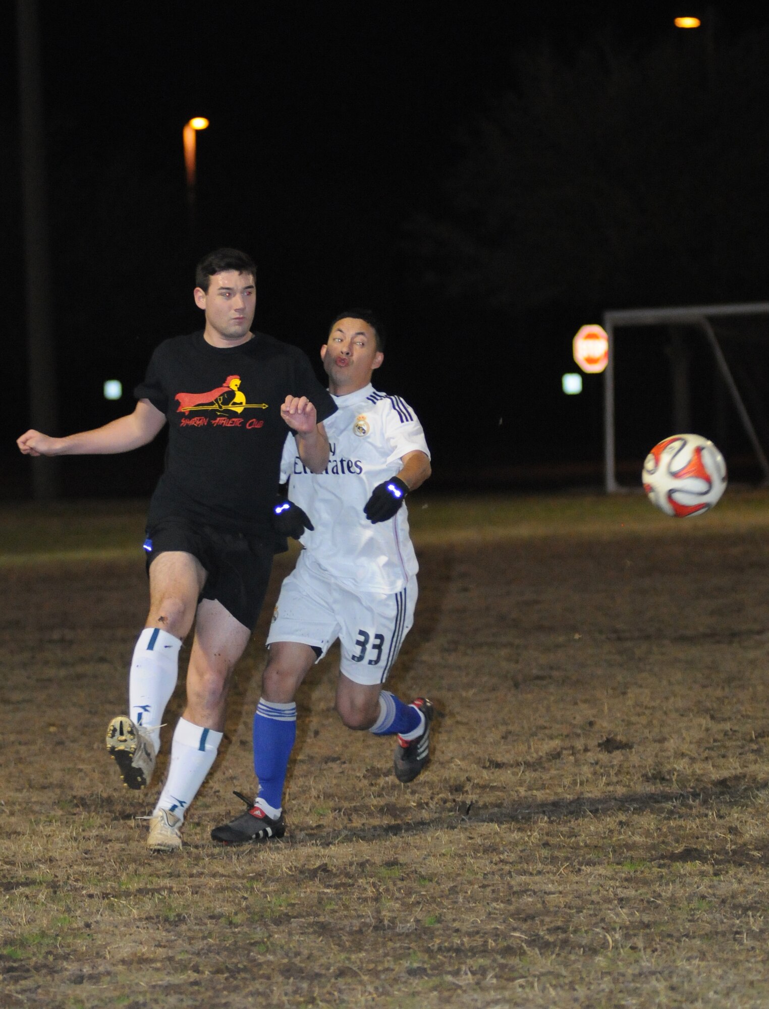 Joseph Schlueter, 333rd Training Squadron A team, kicks the ball as Jorge Panama, 81st Surgical Operations Squadron, closes in during the intramural soccer conference championship game Feb. 5, 2015, at Keesler Air Force Base, Miss. The 81st MSGS defeated 333rd TRS A team, 3-2. The 81st MSGS was the La Liga League champion while the 333rd TRS A team was the Premier League champion. (U.S. Air Force photo by Kemberly Groue)