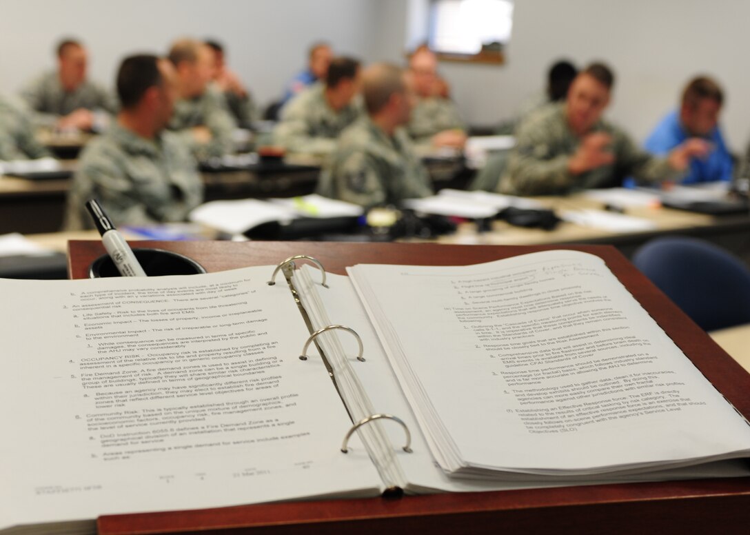 Students discuss practices used at their home stations during the Fire Officer III training course at Fort Eustis, Va., Feb. 6, 2015. Military and civilian firefighters from various Air Combat Command bases attended this course to further their professional development. Graduates of this course are qualified to manage and assist in managing base fire stations. (U.S. Air Force photo by Staff Sgt. Natasha Stannard/Released)