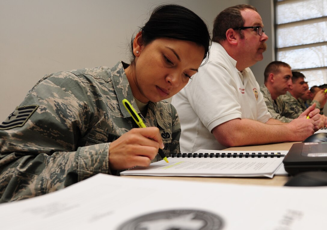 U.S. Air Force Tech Sgt. Vanessa Wyatt, 99th Civil Engineer Squadron fire department training manager, highlights lecture notes during the Fire Officer III training course at Fort Eustis, Va., Feb. 6, 2015. Wyatt is stationed at Nellis Air Force Base, and is taking the course to gain certifications required to fill upper management positions. (U.S. Air Force photo by Staff Sgt. Natasha Stannard/Released)