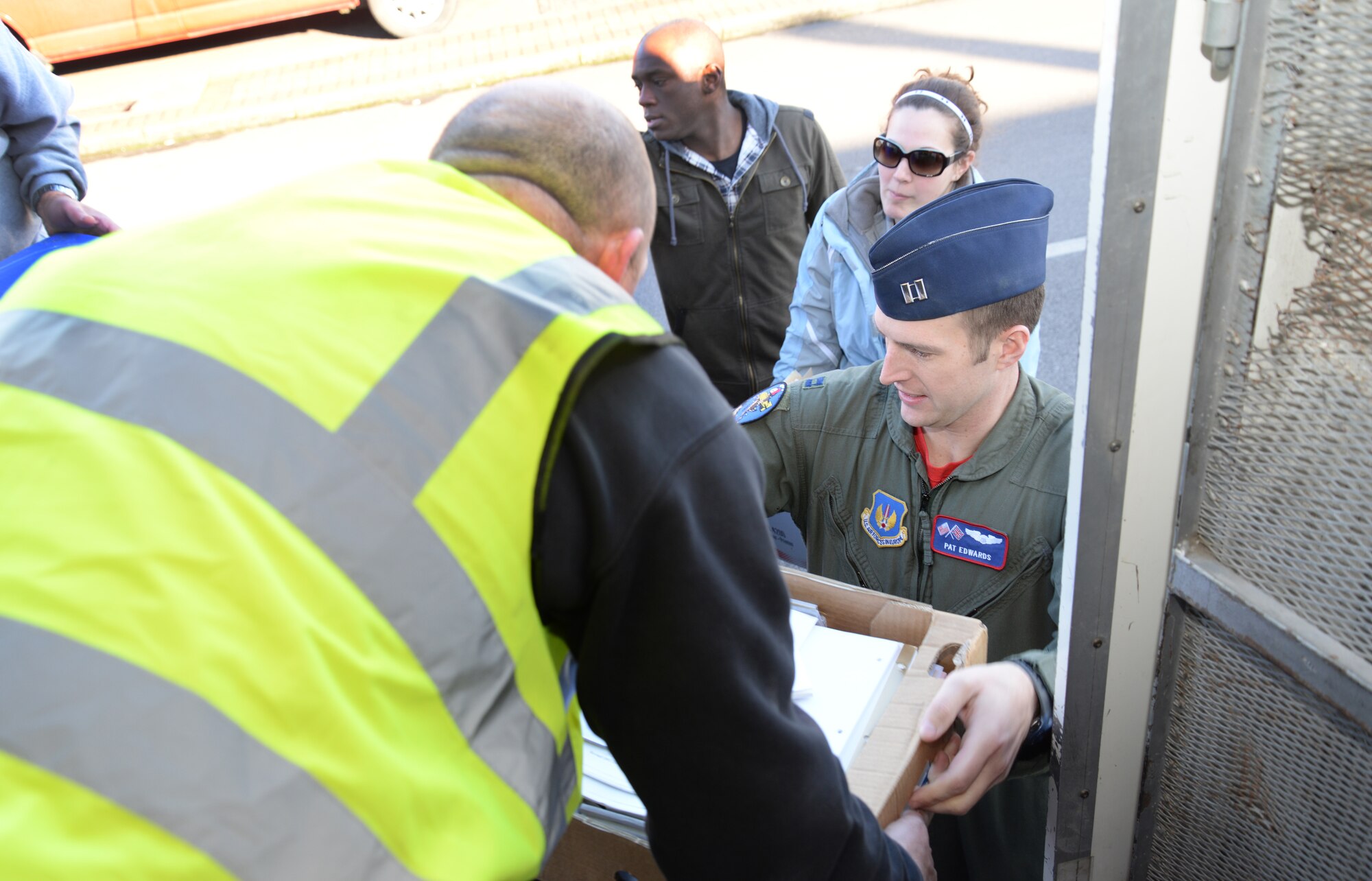 Scott Taylor, left, Shred Station contractor from Harlow, Essex, receives paper from Team Mildenhall members to be shredded Feb. 6, 2015, on RAF Mildenhall, England. The shred truck is one of the ways Team Mildenhall members meet the base’s 100 percent shred policy. (U.S. Air Force photo by Airman 1st Class Jonathan Light/Released)