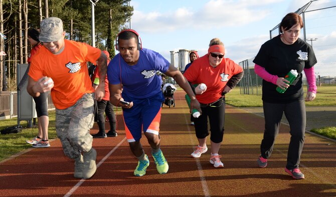 Team Mildenhall members push off the starting line of a relay race Feb. 6, 2015, at Heritage Park on RAF Mildenhall, England. The relay race was the first competition held for the Biggest Loser program. (U.S. Air Force photo by Airman 1st Class Jonathan Light/Released)