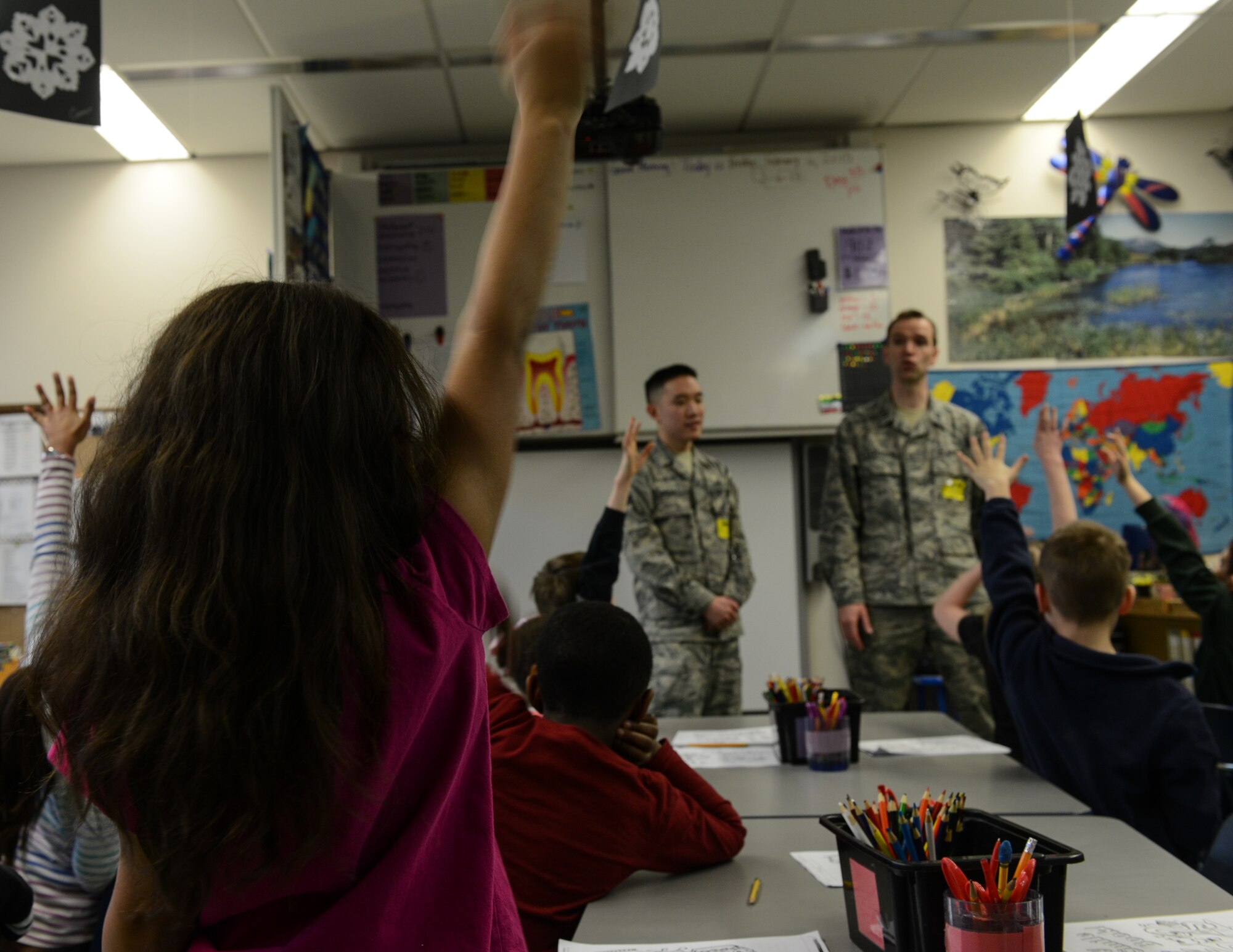 A student raises her hand during a presentation by the 86th Dental Squadron at Ramstein Air Base, Germany, Feb.  6, 2014. The 86th Dental Squadron visits Ramstein Elementary School annually during Children’s Dental Health Month.  (U.S. Air Force photo/Senior Airman Nicole Sikorski)

