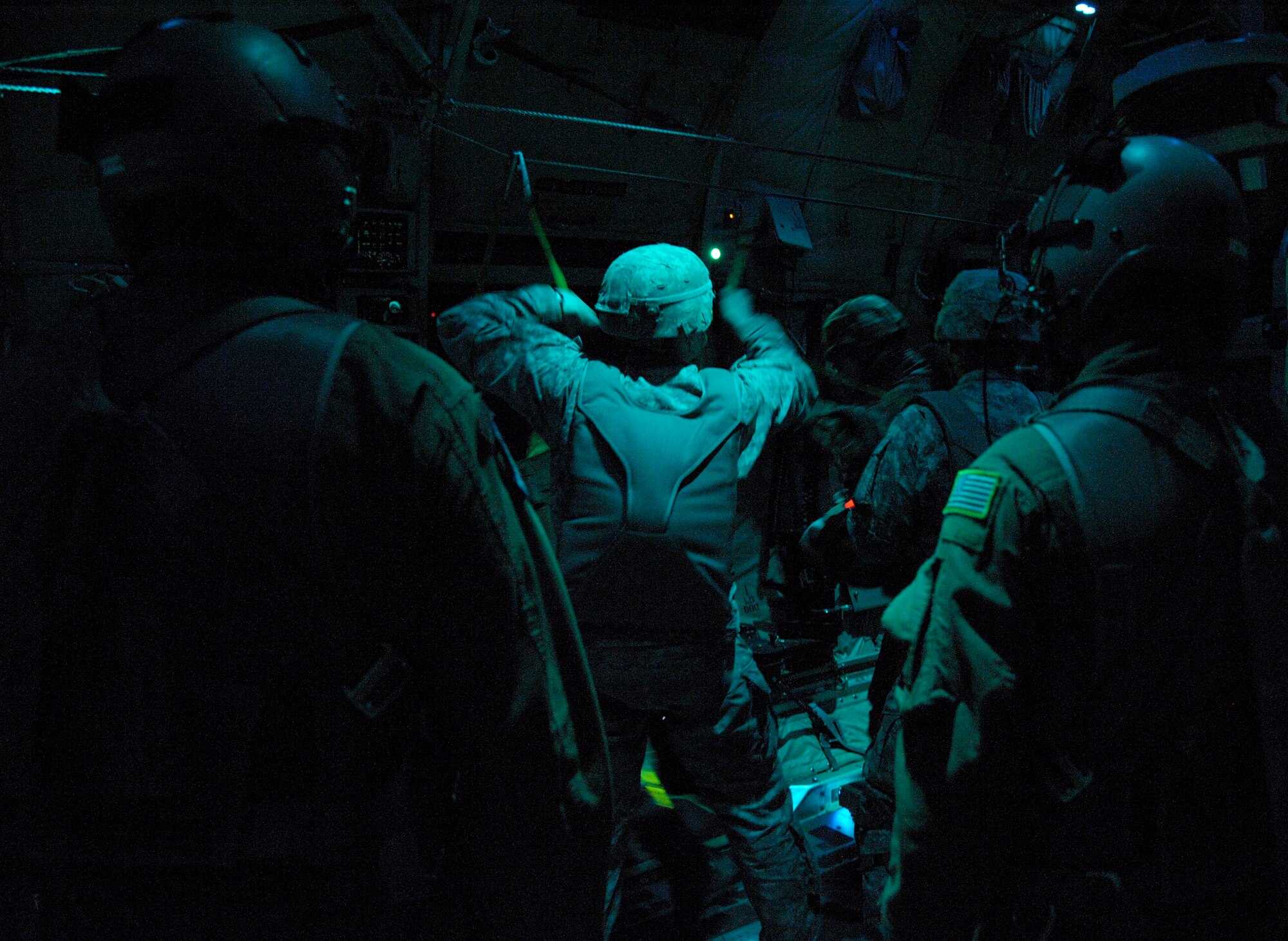 Staff Sgts. Joshua Nelson (left) and JC Letts, 37th Airlift Squadron loadmasters, watch as U.S. Army jumpmasters help Greek paratroopers get out the door of a C-130J Super Hercules assigned to the 37th AS in Elefsis, Greece, Feb. 4, 2015. The night jump was part of Stolen Cerberus II, a flying training deployment designed to improve the interoperability of the U.S. and one of its NATO allies. (U.S. Air Force photo/Senior Airman Timothy Moore)