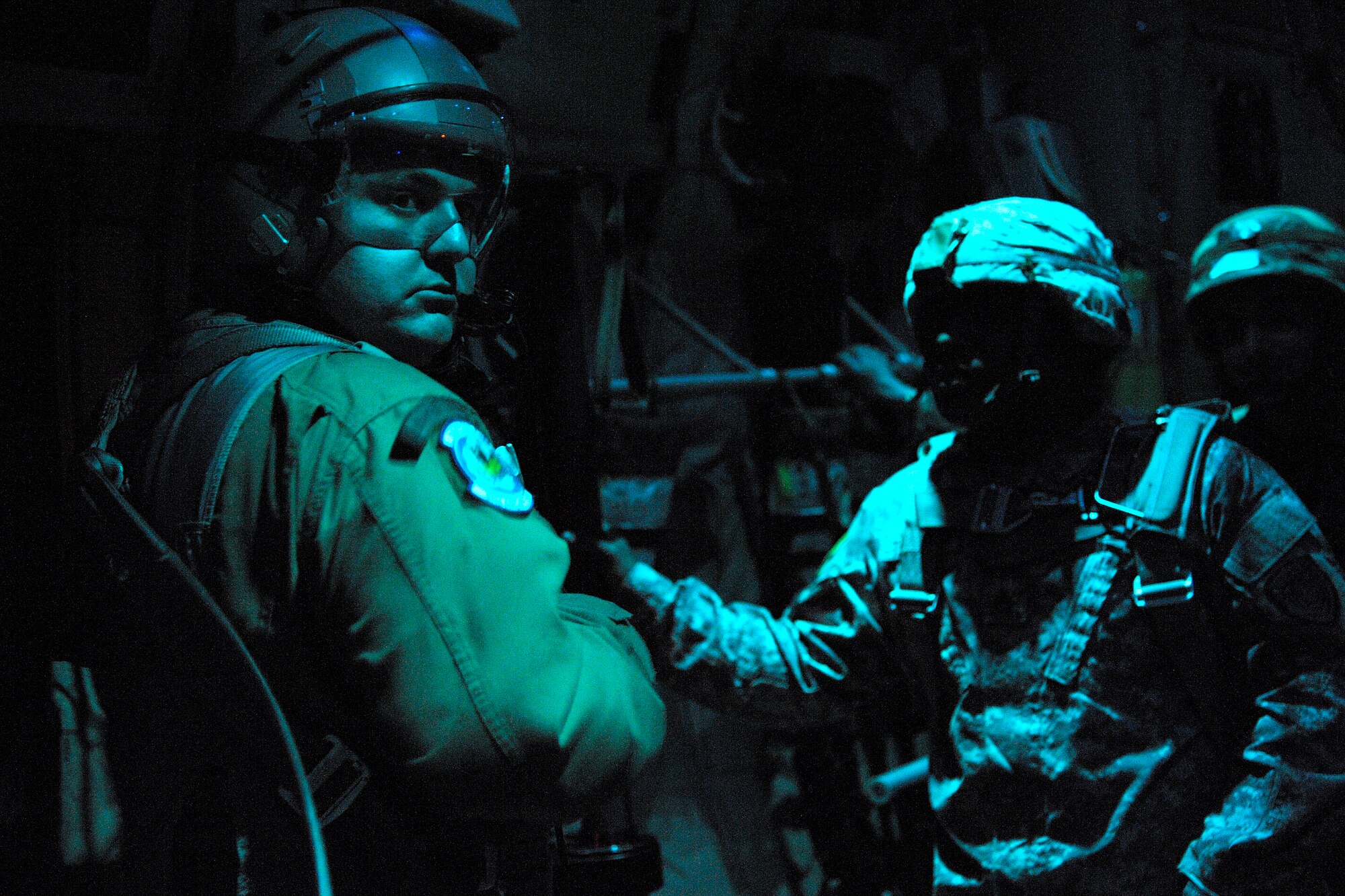 Staff Sgt. Joshua Nelson (left), 37th Airlift Squadron loadmaster, waits to give the "go" signal to U.S. Army jumpmasters and Greek paratroopers on a C-130J Super Hercules on a night flight during the Stolen Cerberus II flying training deployments. The FTD is designed to improve the interoperability of the U.S. and Greek Air Forces. It is being held from Feb. 2 to 14. (U.S. Air Force photo/Senior Airman Timothy Moore)